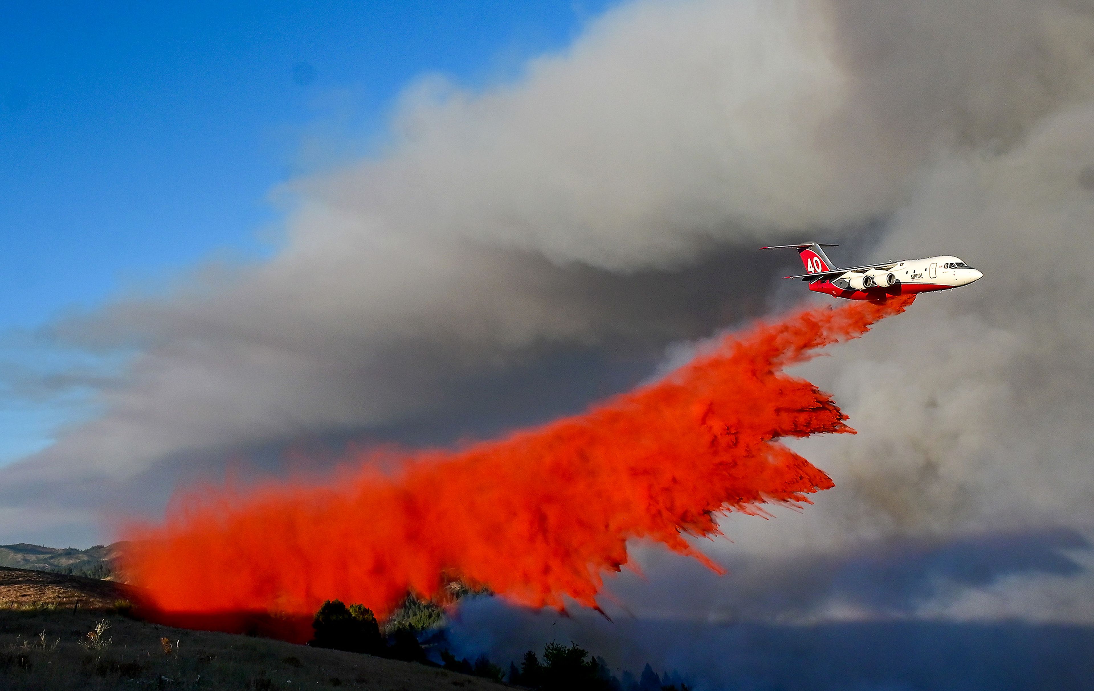 Fire retardant is dumped on the wildfire in the area of Texas Ridge and Cedar Ridge roads near Kendrick on Monday.