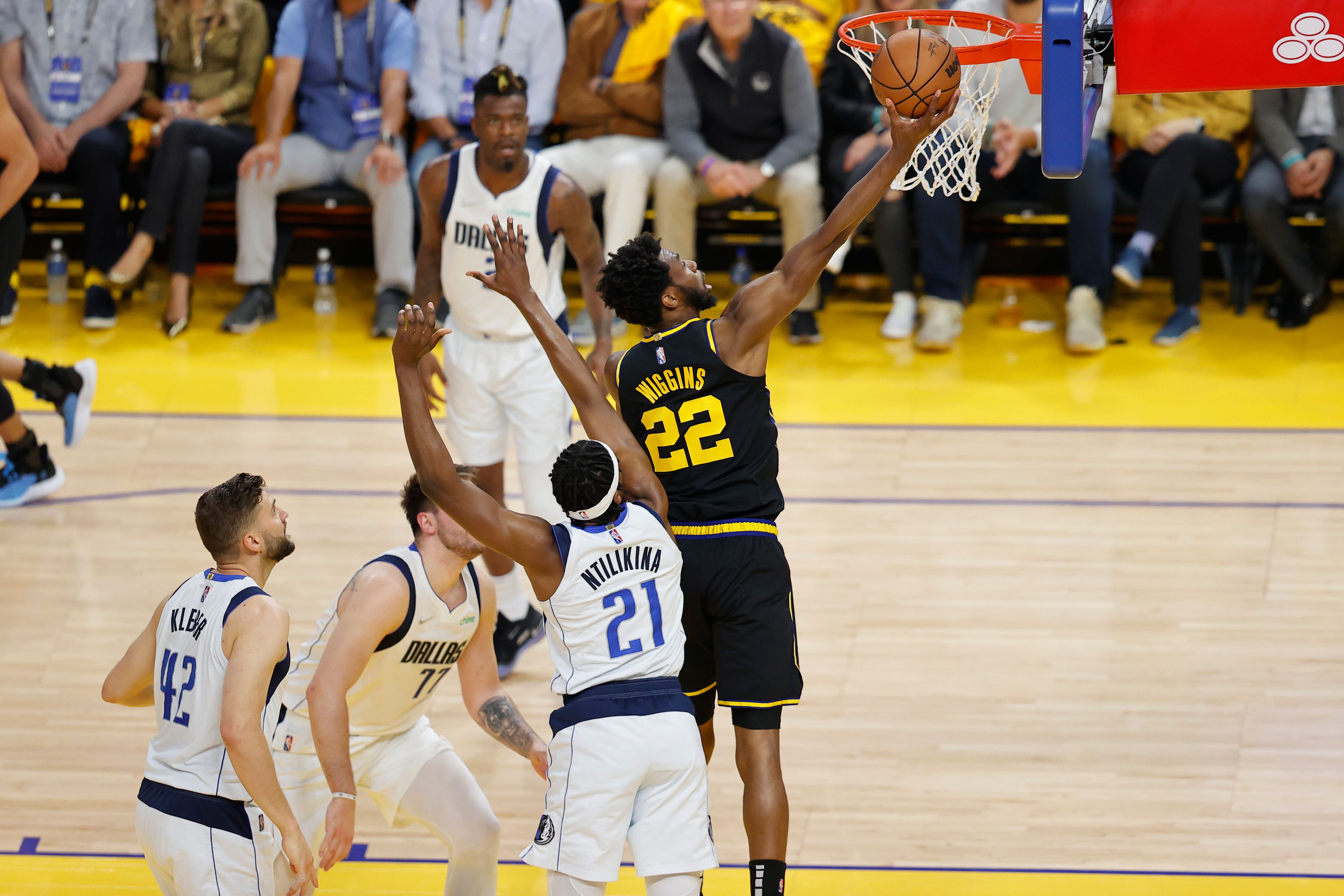 Golden State Warriors forward Andrew Wiggins (22) drives to the basket past Dallas Mavericks guard Frank Ntilikina (21) during the first half in Game 5 of the NBA basketball playoffs Western Conference finals in San Francisco, Thursday, May 26, 2022. (AP Photo/John Hefti)