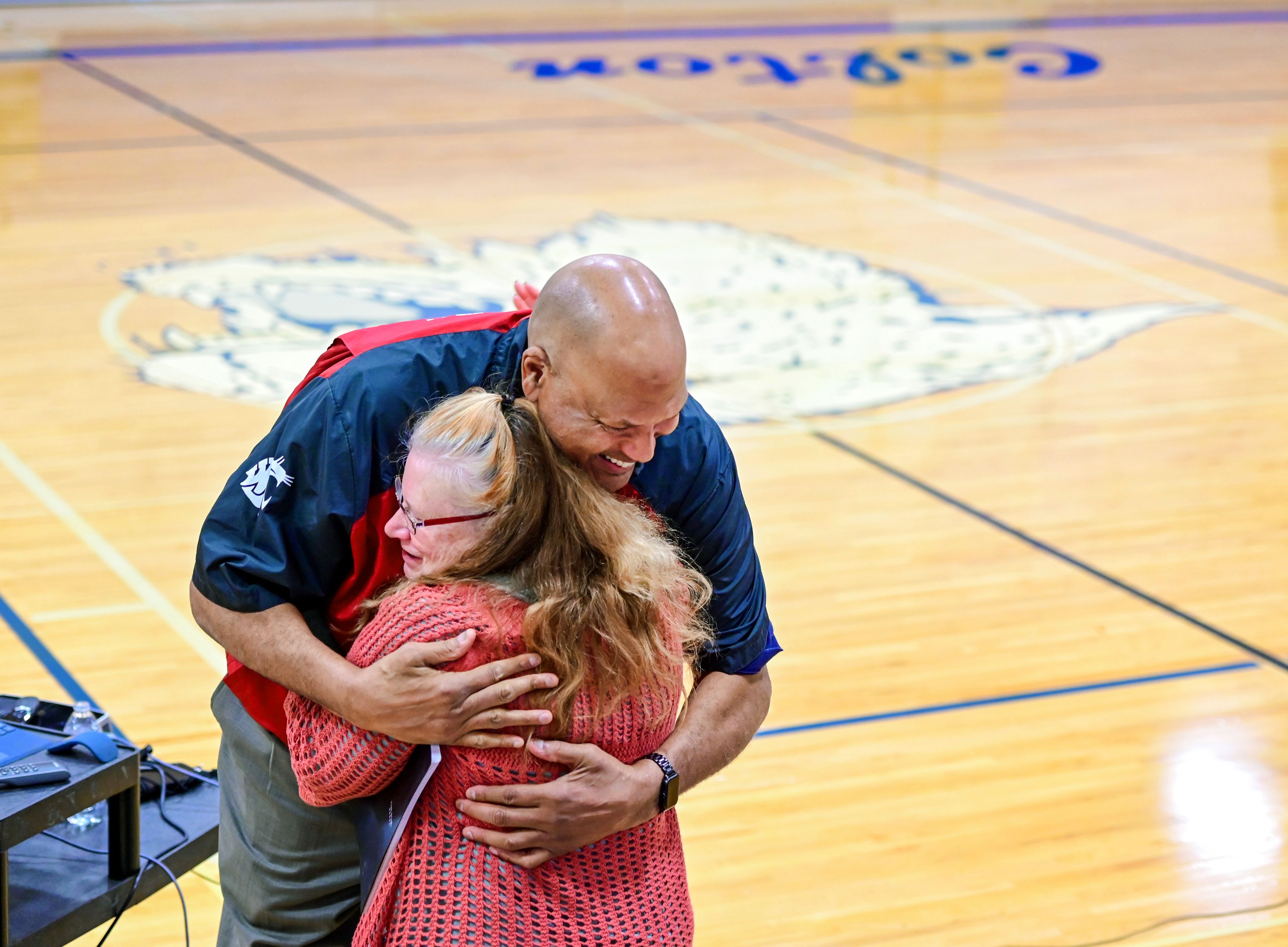 Former NBA and WSU athlete James Donaldson embraces Michele Heitstuman, a Special Education teacher at Colton High School, after Donaldson’s talk about mental health with students on Tuesday.