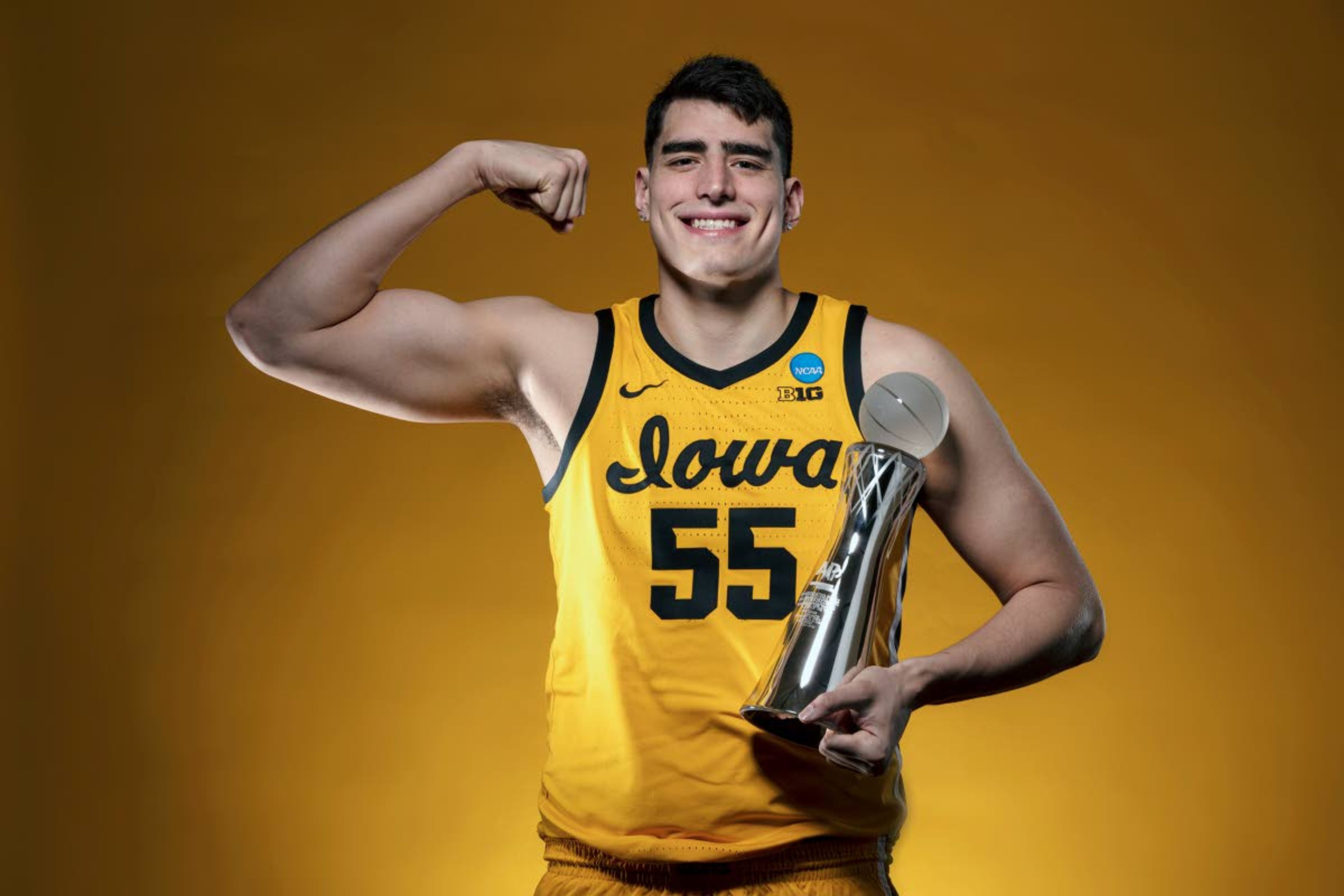 In this photo provided by the University of Iowa, Iowa NCAA college basketball center Luka Garza (55) holds the 2021 AP Player of the Year trophy on Wednesday, March 31, 2021, at Carver-Hawkeye Arena in Iowa City, Iowa. Garza was named The Associated Press men's basketball player of the year on Thursday, April 1. (Brian Ray/University of Iowa Athletics via AP)