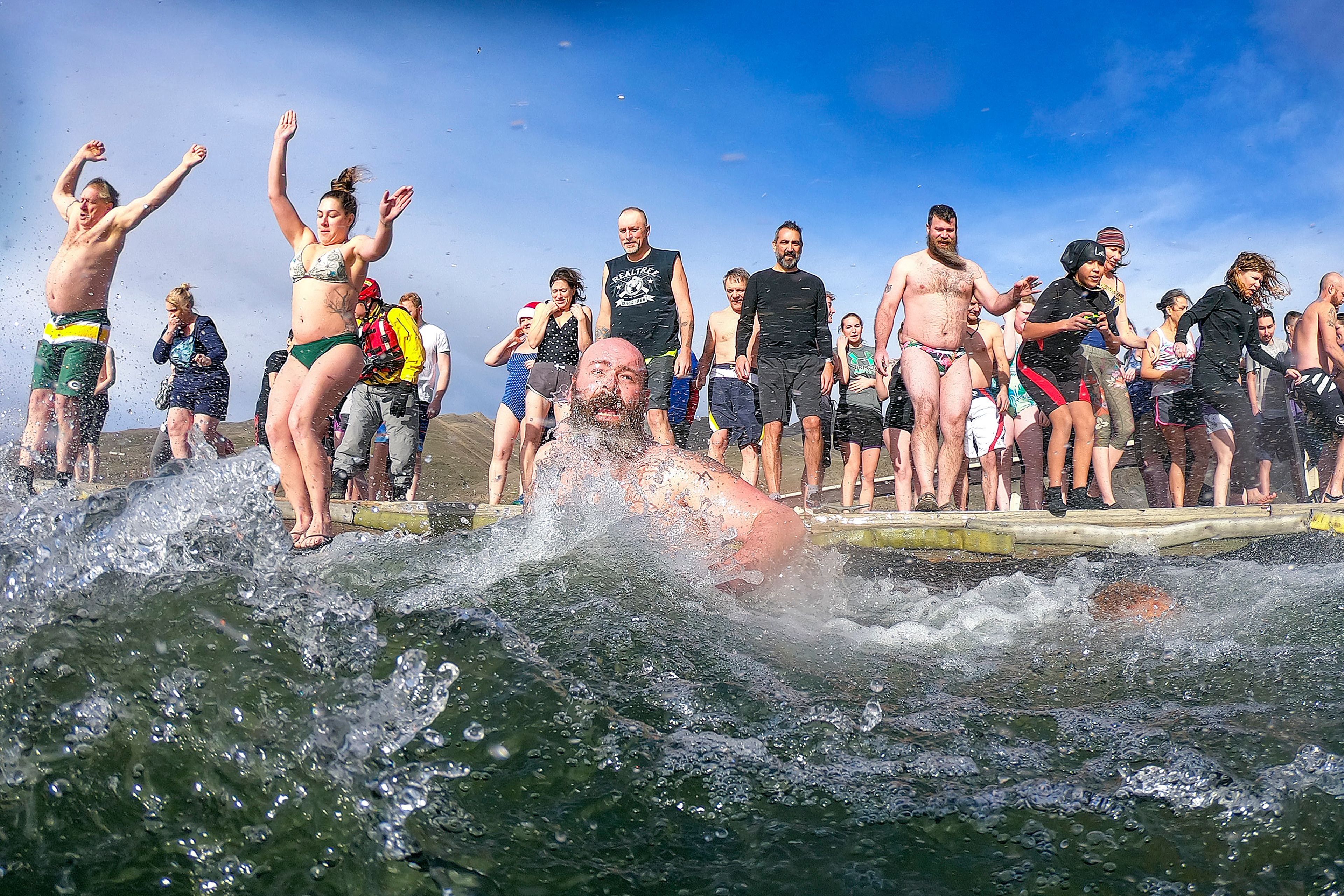 Brave souls leap into the frigid waters of the Snake River for the annual Polar Plunge on Wednesday in Clarkston.