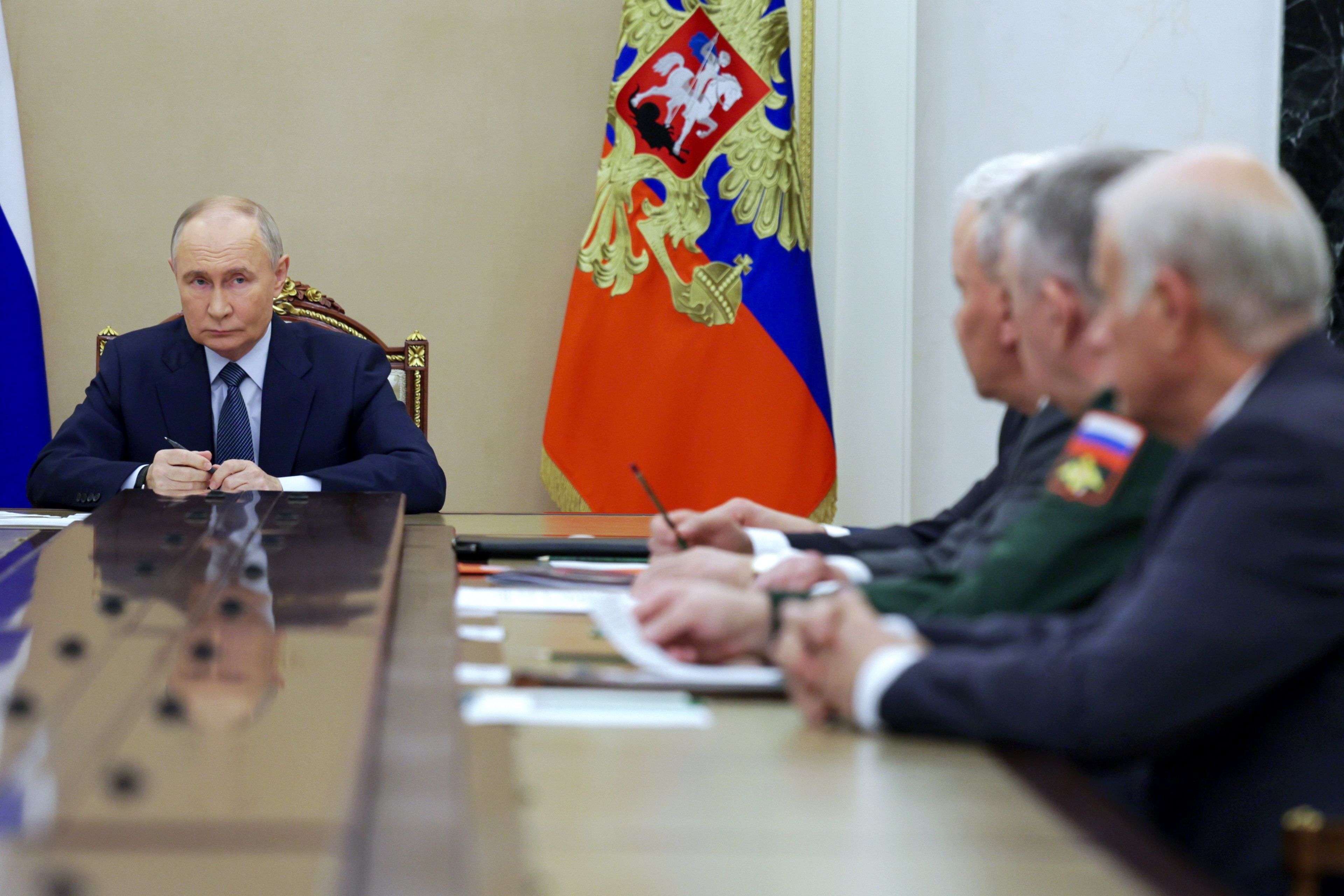 FILE - Russian President Vladimir Putin, left, speaks during a meeting with the leadership of the Russian Ministry of Defense, representatives of the military-industrial complex and developers of missile systems at the Kremlin in Moscow, Russia, Friday, Nov. 22, 2024. (Gavriil Grigorov, Sputnik, Kremlin Pool Photo via AP, File)