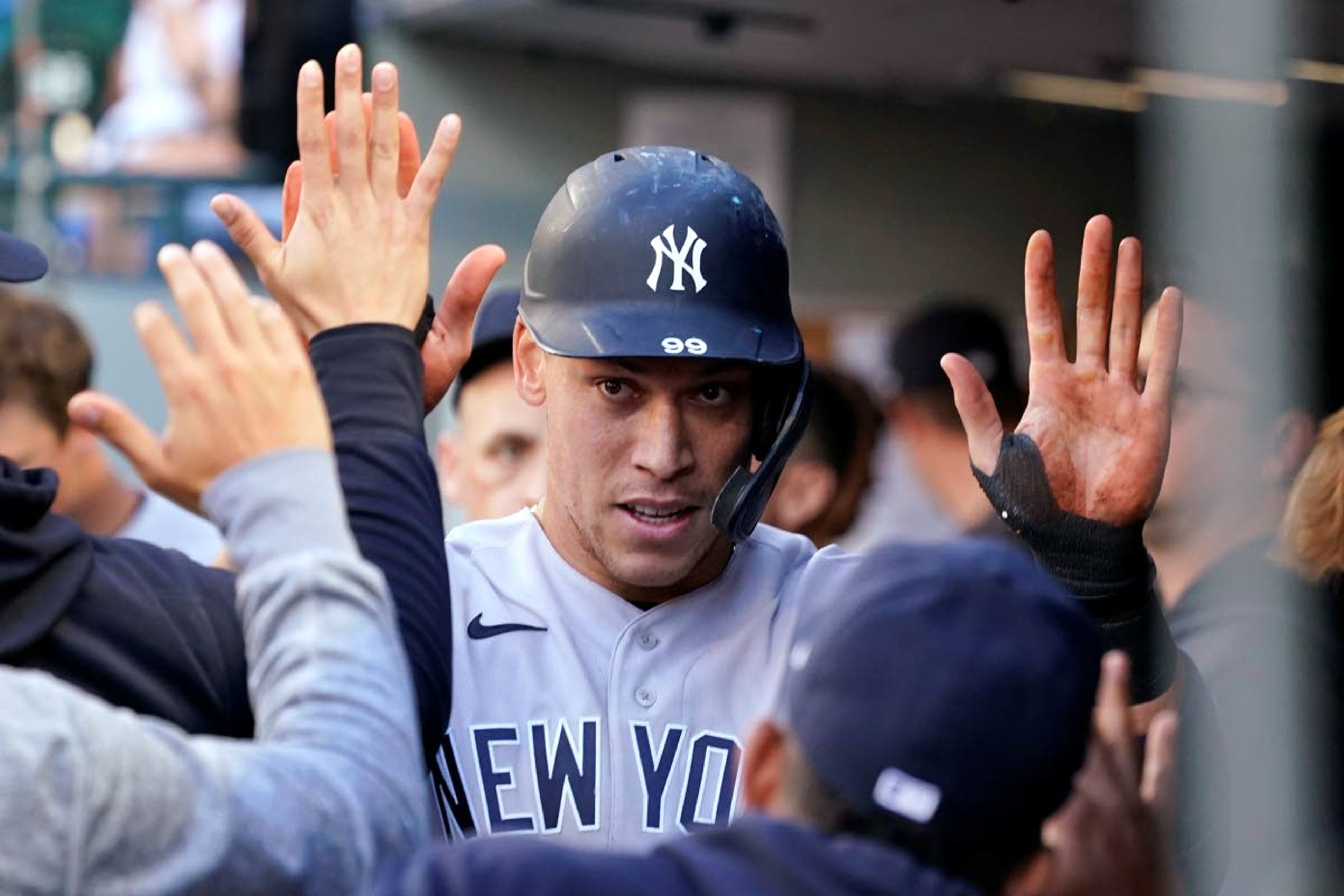 New York Yankees' Aaron Judge is congratulated after scoring against the Seattle Mariners during the first inning of a baseball game Wednesday, July 7, 2021, in Seattle. (AP Photo/Elaine Thompson)