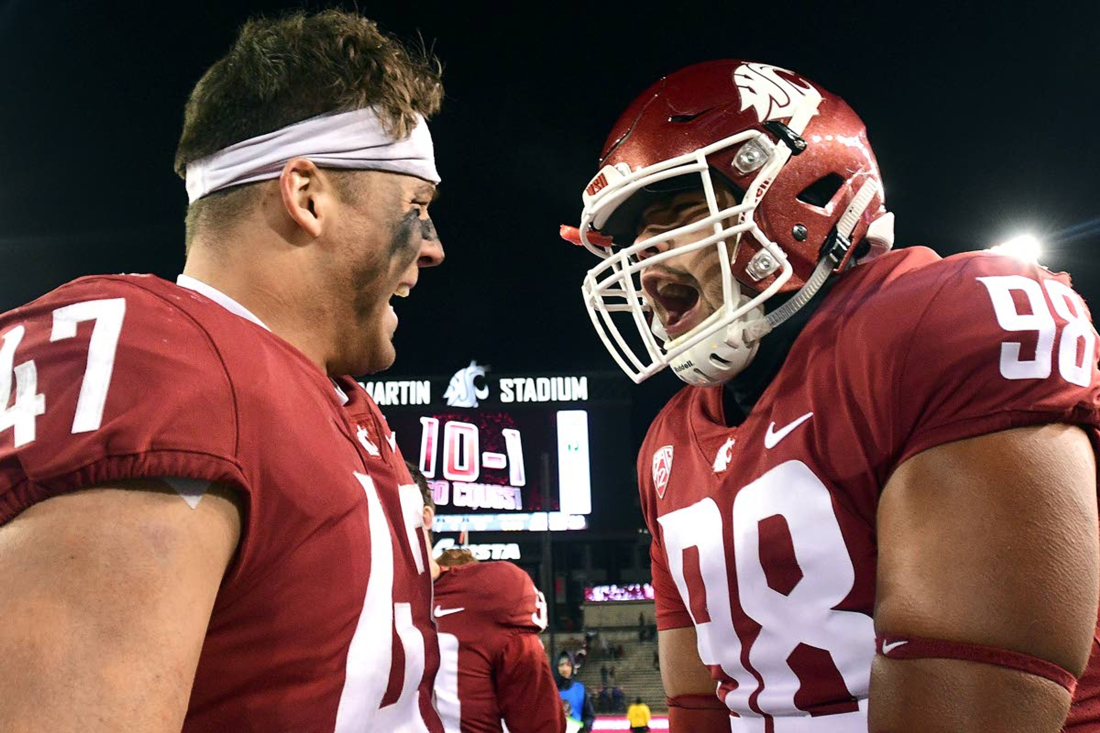 Washington State linebacker Peyton Pelluer (47) and defensive lineman Dallas Hobbs (98) celebrate after the Cougars beat Arizona, 69-28, in a Pac-12 Conference game Nov. 17, 2018, at Martin Stadium in Pullman. Hobbs is one of several Pac-12 athletes threatening to boycott the conference.