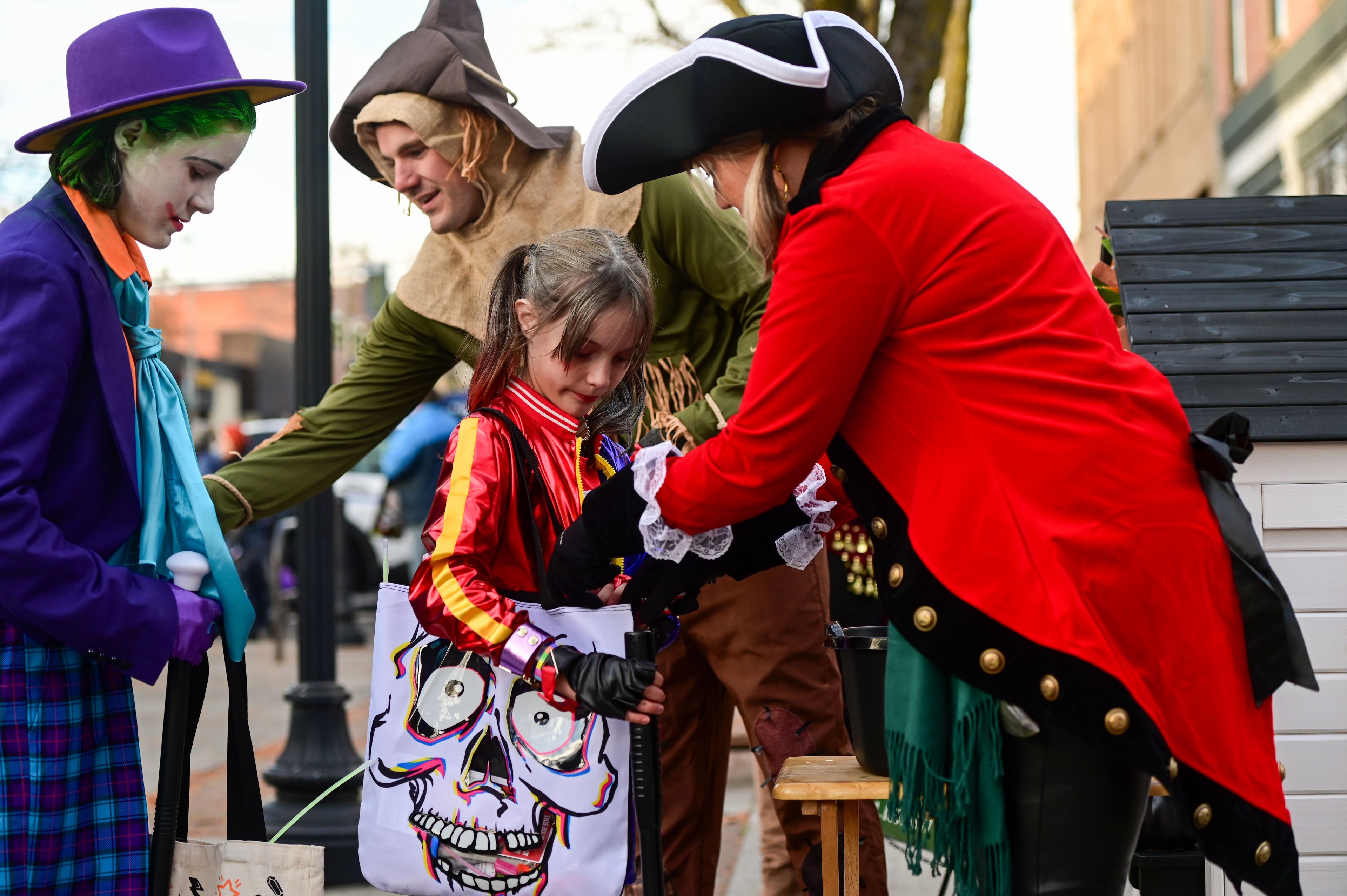 A Joker and Harley Quinn pair receive candy at Moscow’s Downtown Trick-or-Treat on Tuesday.