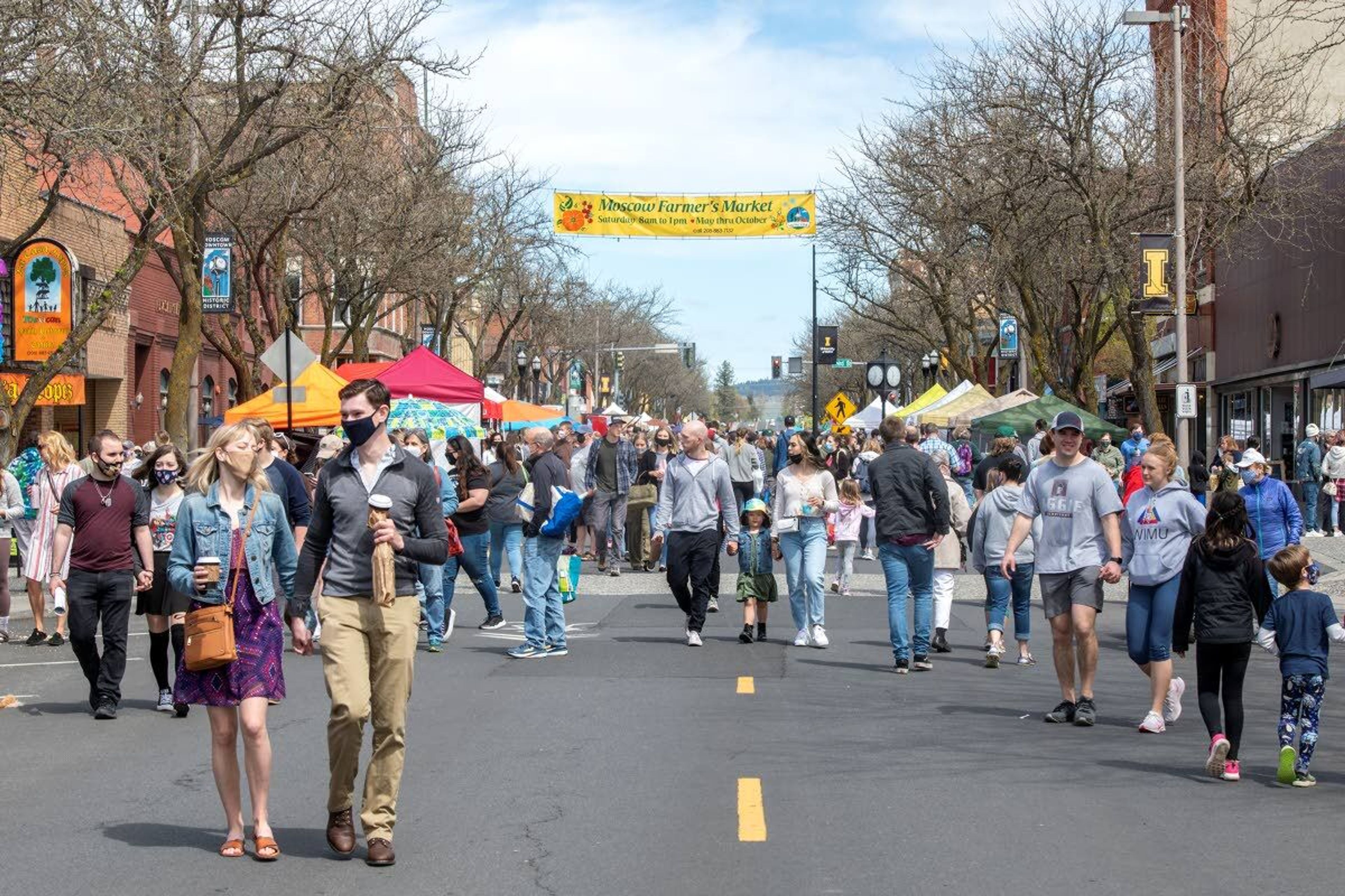 Visitors walk along Main Street in downtown Moscow for the first farmers market of the year.