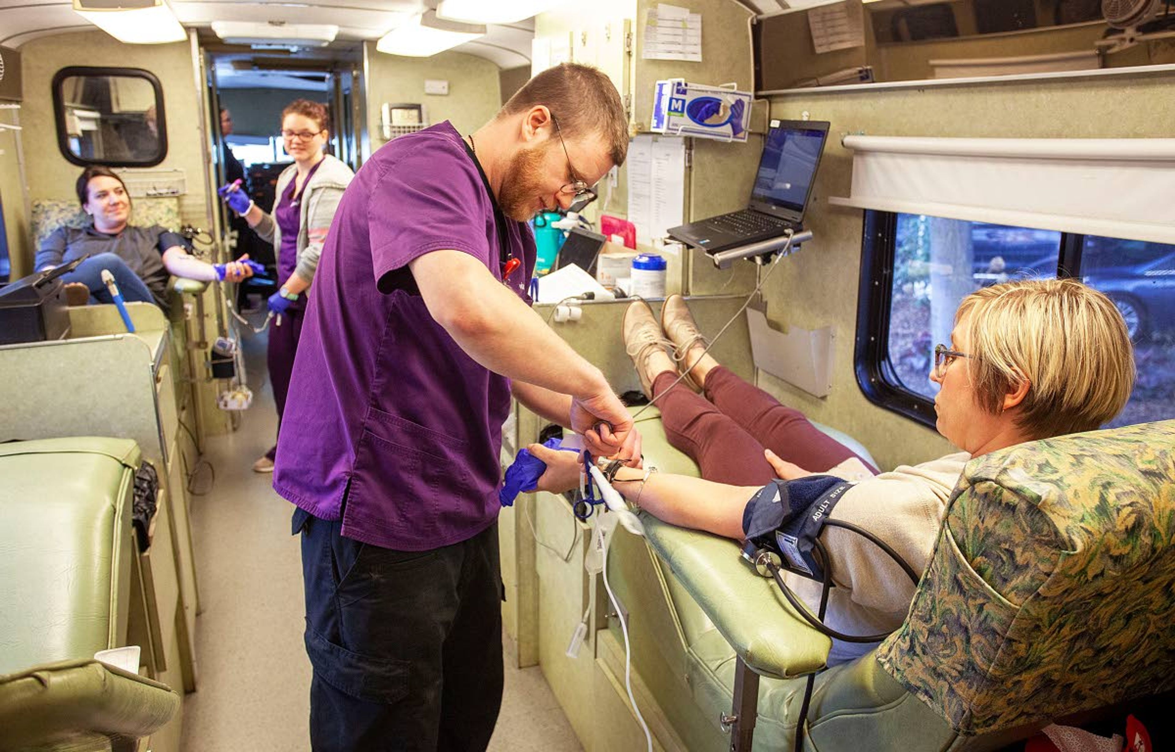 Phlebotomists Tyler Covey, center, and Cori Keeler help city of Pullman employees Megan Vining, right, and Cristin Reisenaur donate blood during a blood drive Wednesday outside Pullman City Hall. Vitalant is encouraging people to donate blood because some regular donors are staying home because they are concerned about the COVID-19 virus.