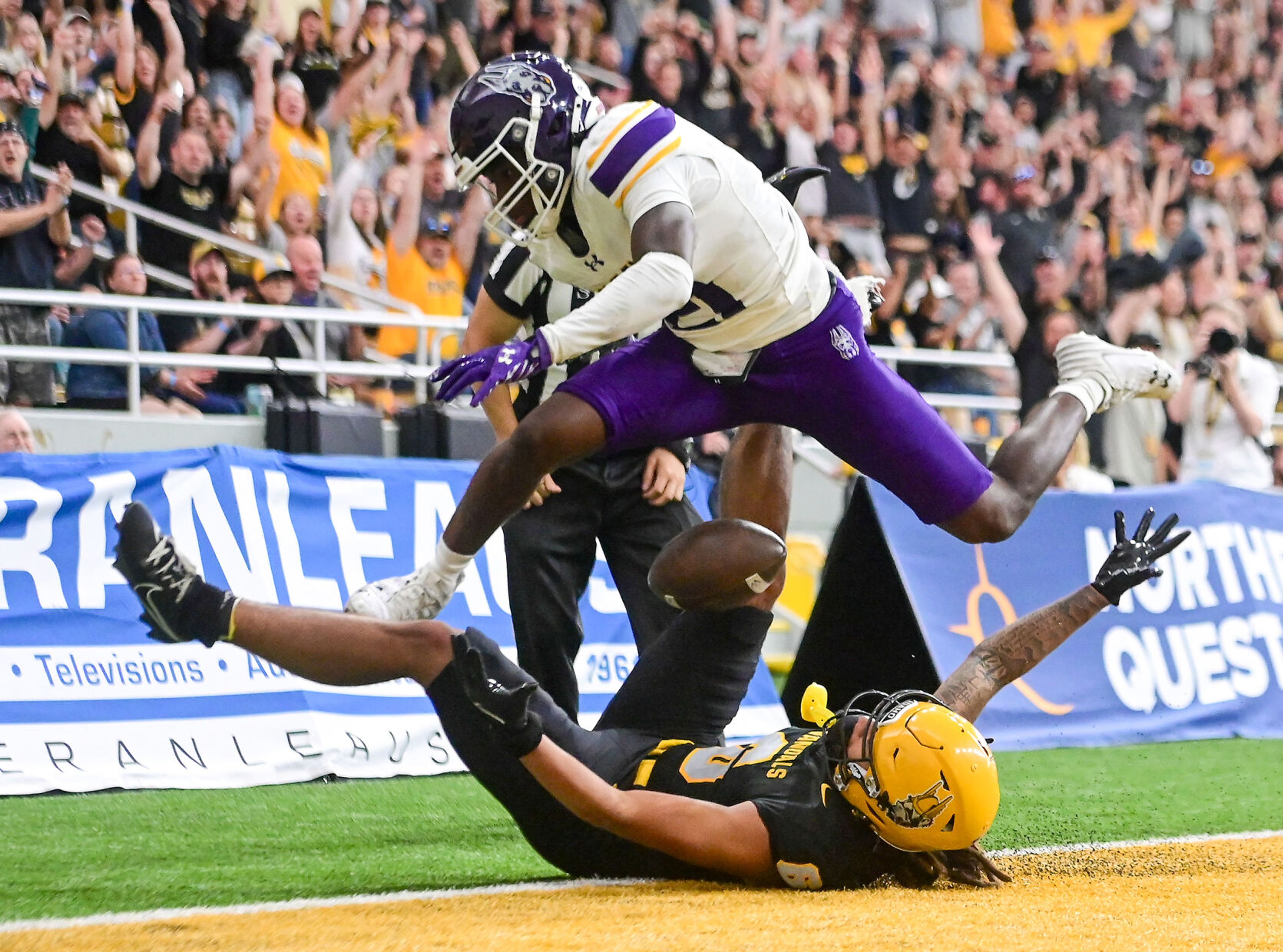 Idaho wide receiver Jordan Dwyer lands after attempting a touchdown catch in front of UAlbany defensive back Erv Wiggins Jr. during a game Saturday at the Kibbie Dome in Moscow.