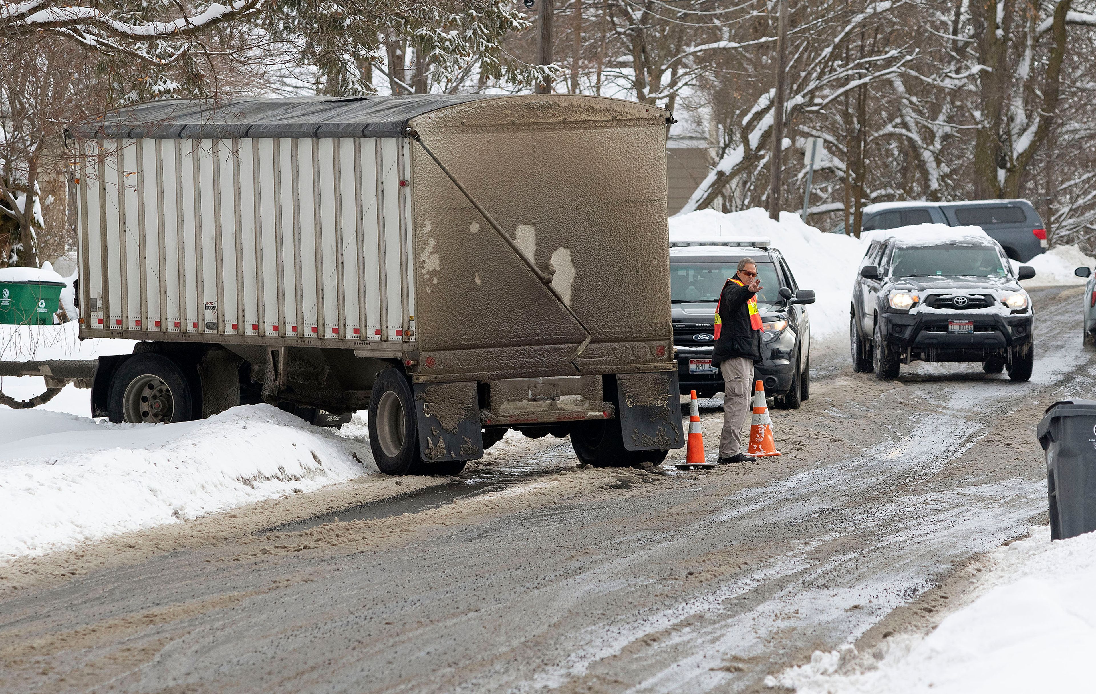 Code Enforcement Officer Alan Johnson directs traffic around a semitractor-trailer that got stuck on Thursday at the intersection of East D Street and North Van Buren Street in Moscow.