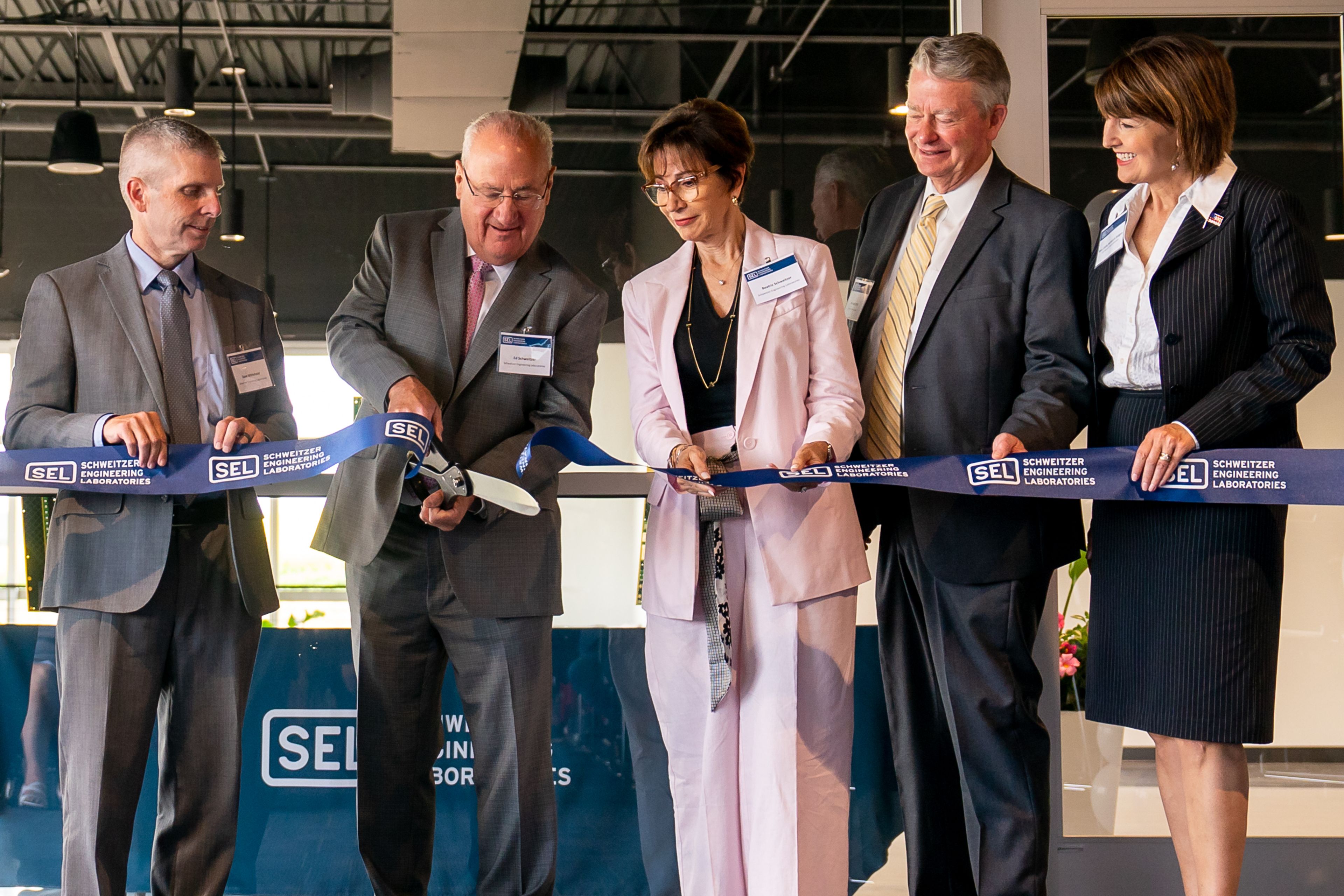 Schweitzer Engineering Laboratories President and Chief Technology Officer Edmund O. Schweitzer, III, second from right, cuts a ribbon during a ceremony for SEL’s new printed circuit board factory in Moscow on Wednesday.