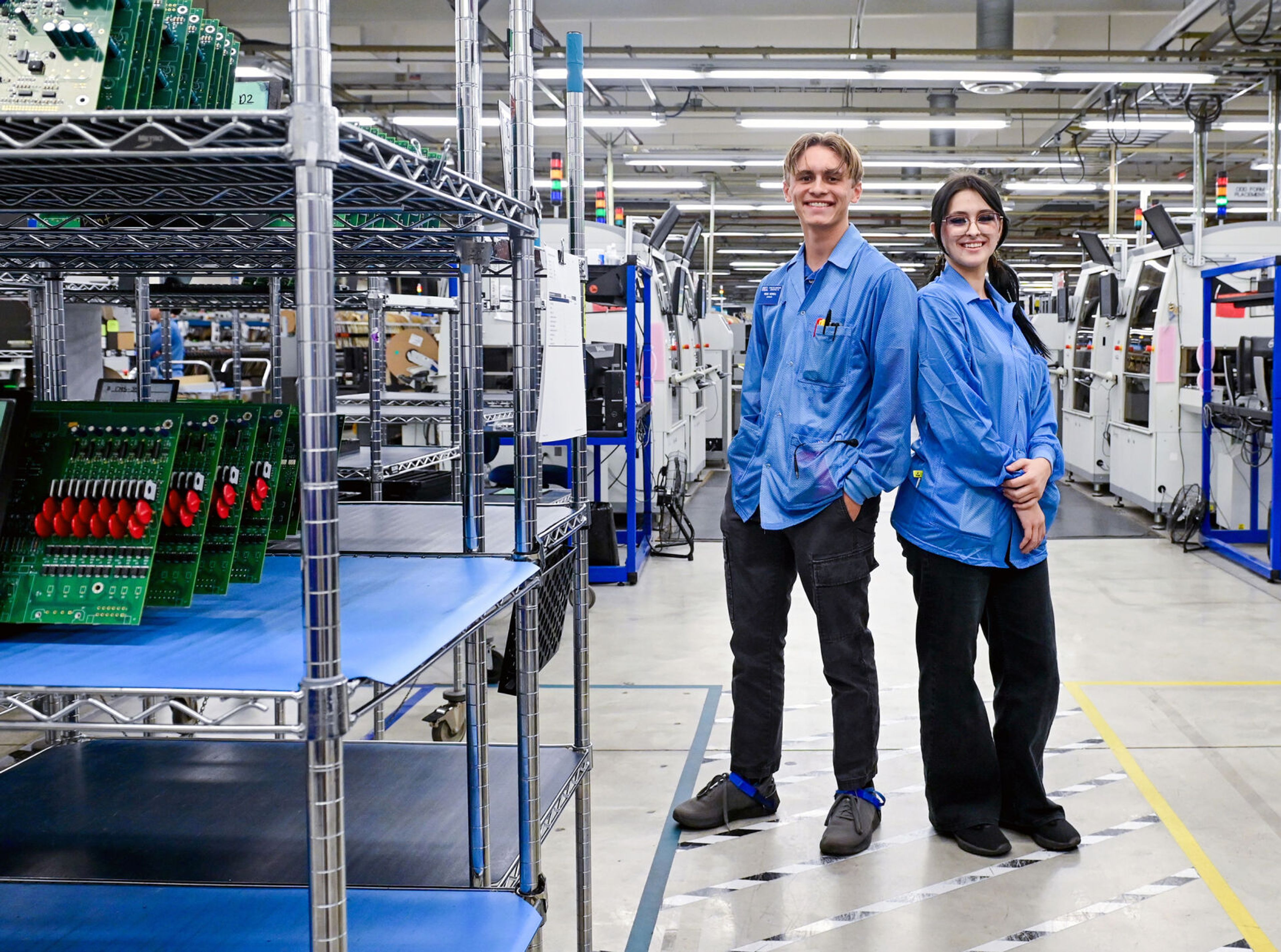 Pullman High School seniors and members of the Summer Assembler Program Reed Newell, left, and Anina Swanson stand at Schweitzer Engineering Laboratories, where the two worked over the summer, on Thursday in Pullman.