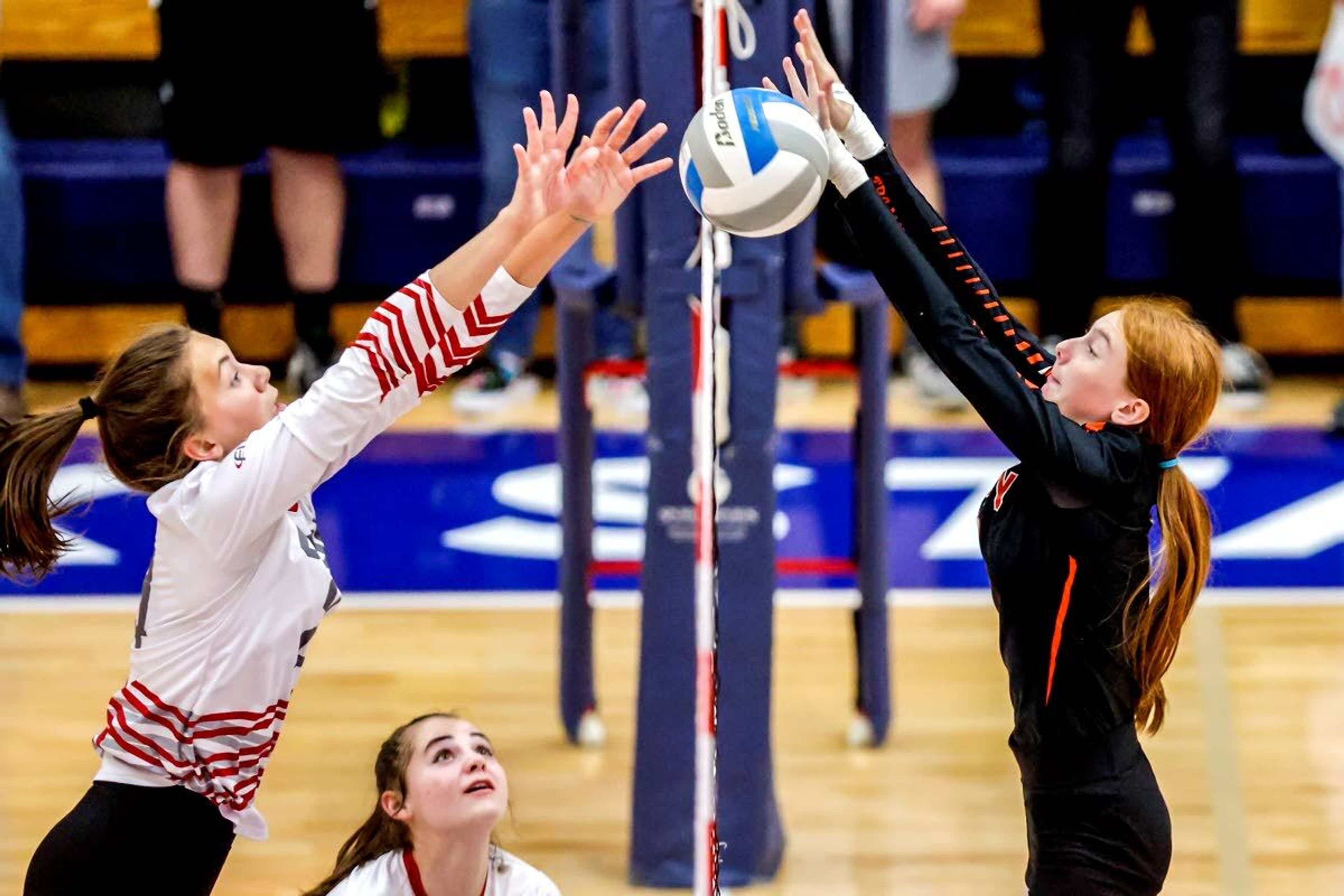 Troy outside hitter Dericka Morgan, right, and Grace’s Tayler Yost leap up to try to hit the ball during the Idaho Class 1A Division I state volleyball championship match Saturday at Lewis-Clark State’s Activity Center.