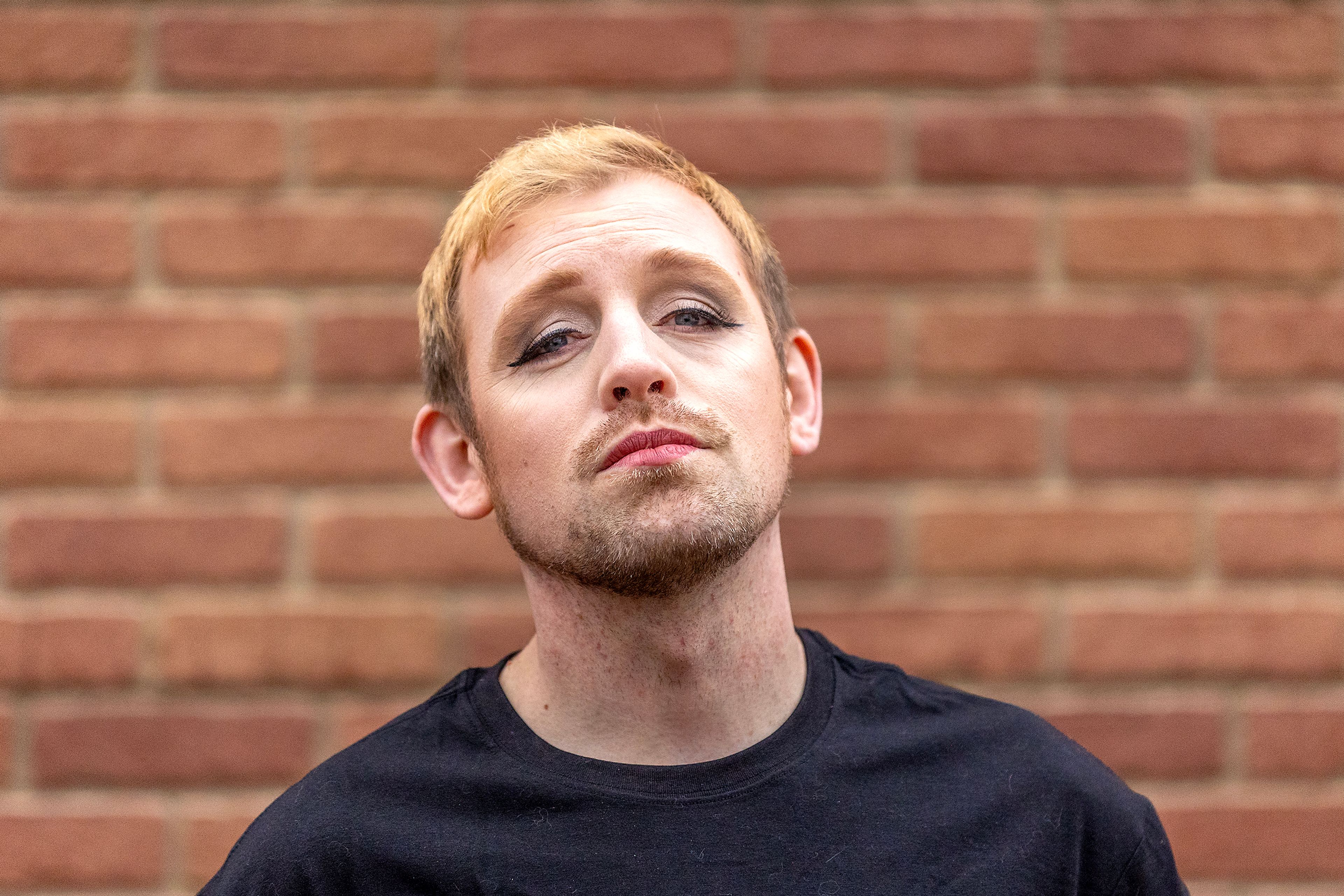 Micheal Keene poses for a photo wearing 2010s-inspired makeup applied by Jacey Johnson.