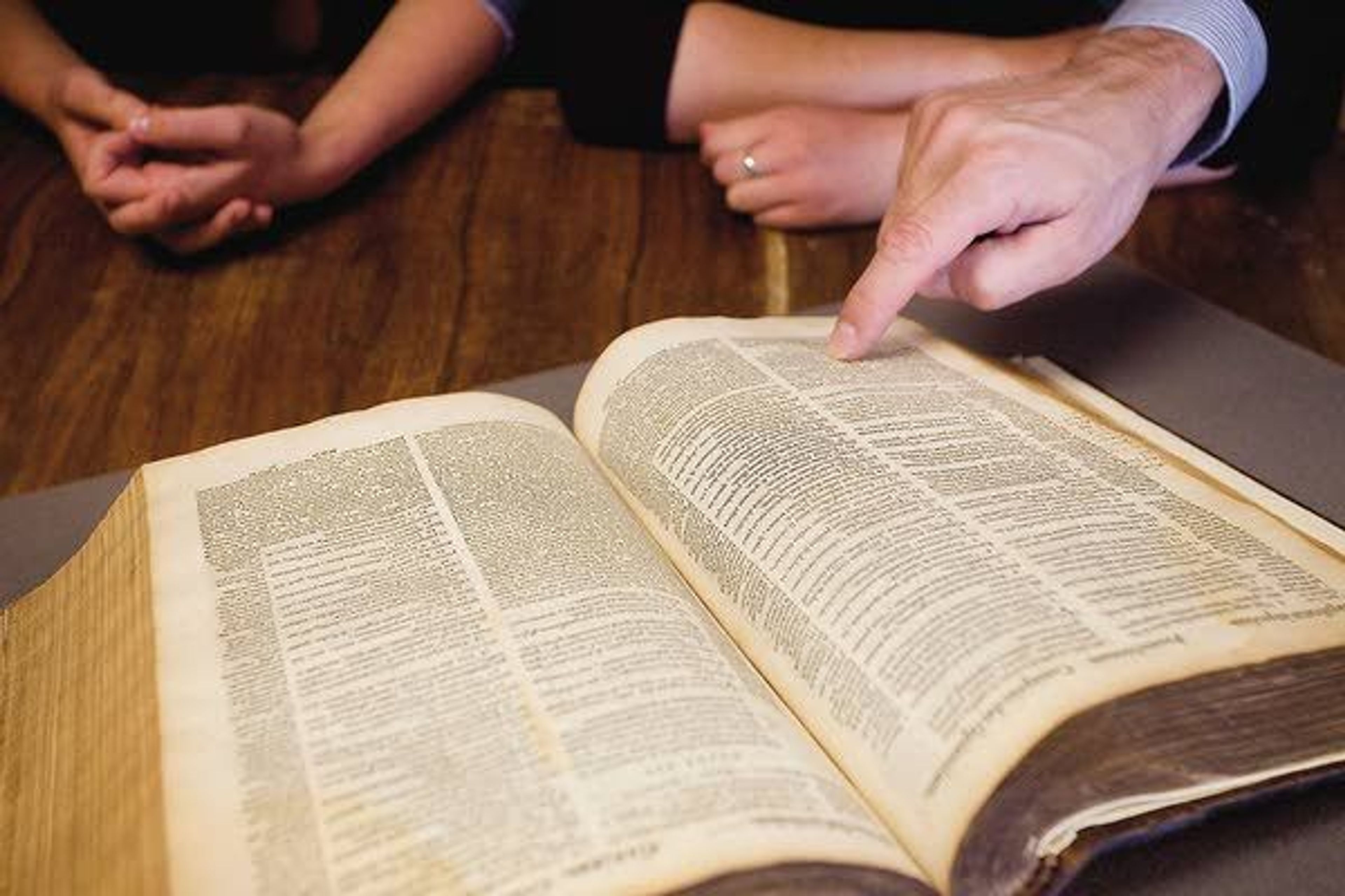 New Saint Andrews College's new president, Ben Merkle, points to a passage in the Latin text of a 1593 Junius Tremellius Bible while meeting with a group of students in Moscow on Wednesday.