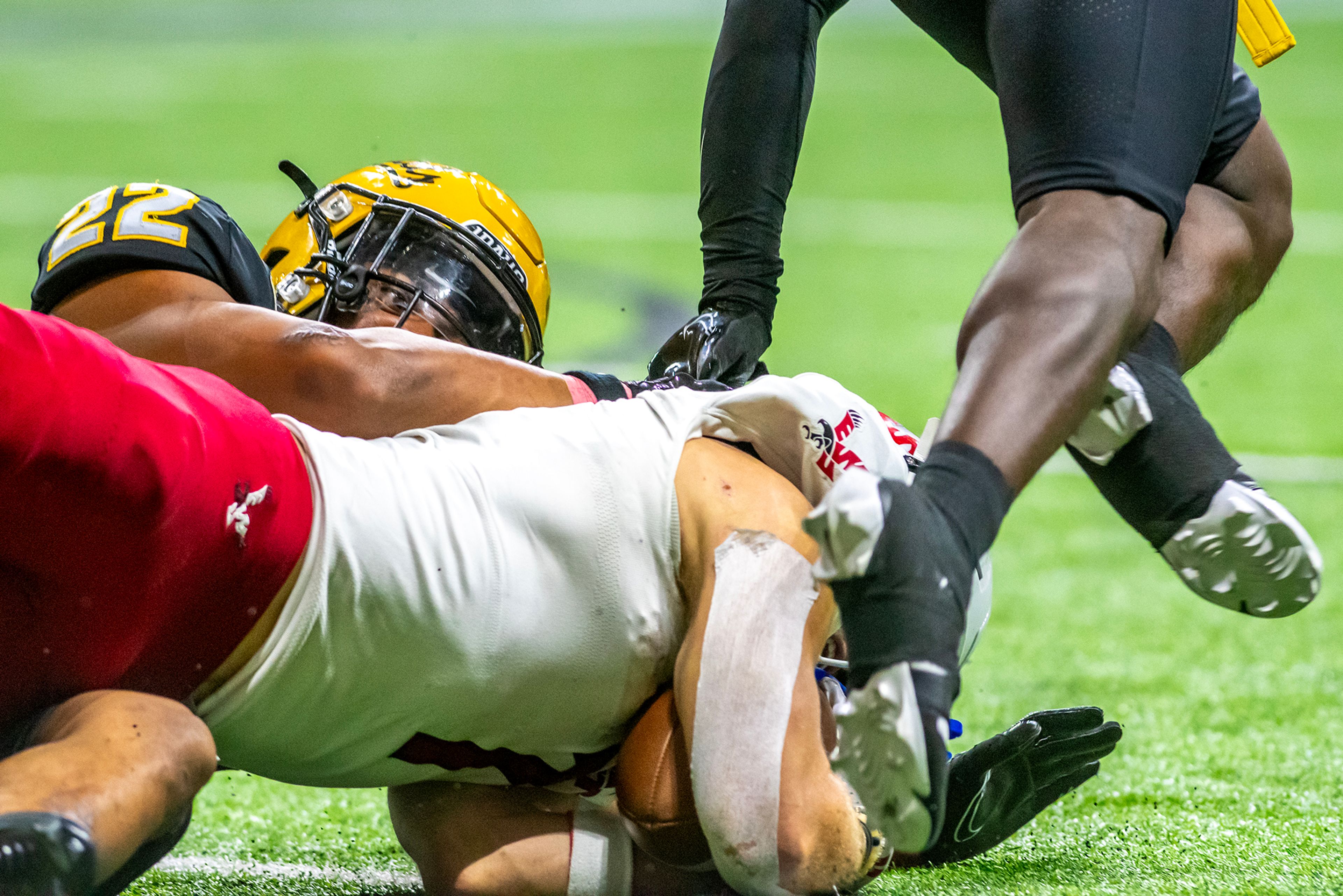 Idaho defensive back Dwayne McDougle tackles Eastern Washington cornerback Cage Schenck to take over on downs during a Big Sky game Saturday at the Kibbie Dome in Moscow. ,