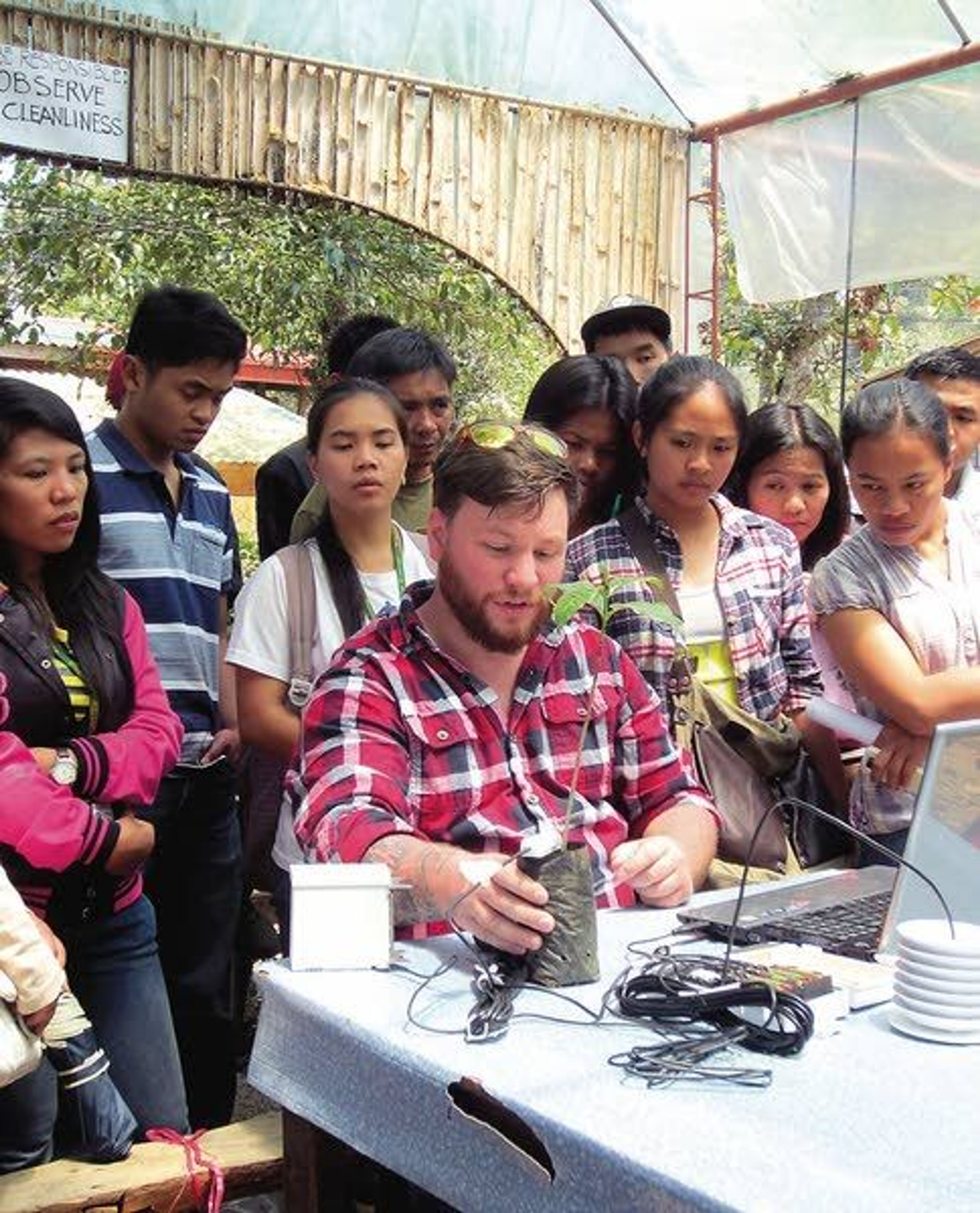 Image 4096 is a photo of a student, Nathan Suhr, demonstrating how to use the soil moisture sensor donated by Decagon Devices of Pullman, to students at Benguet State University.