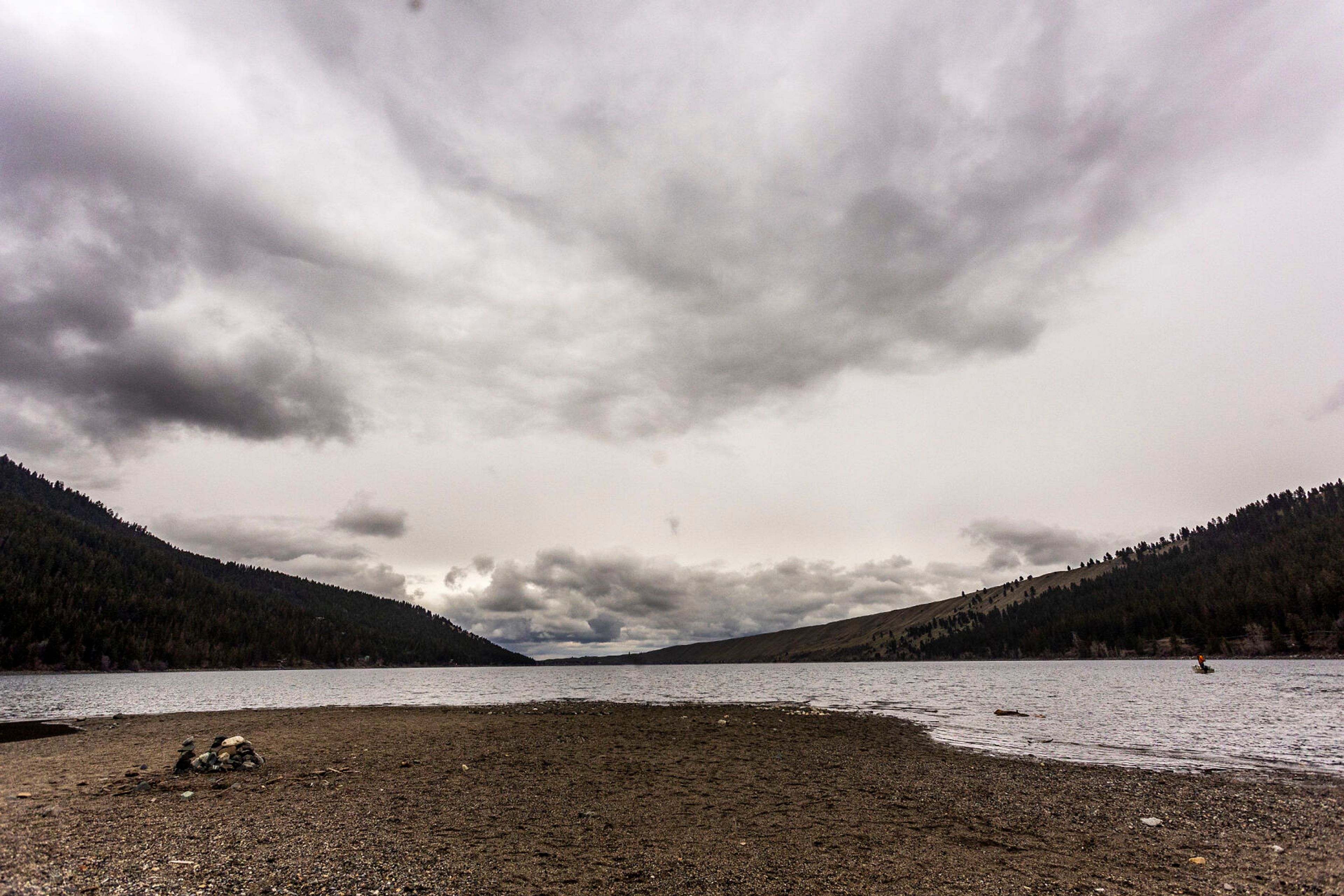 A rocky sandbar extends out into Wallowa Lake on the south end.