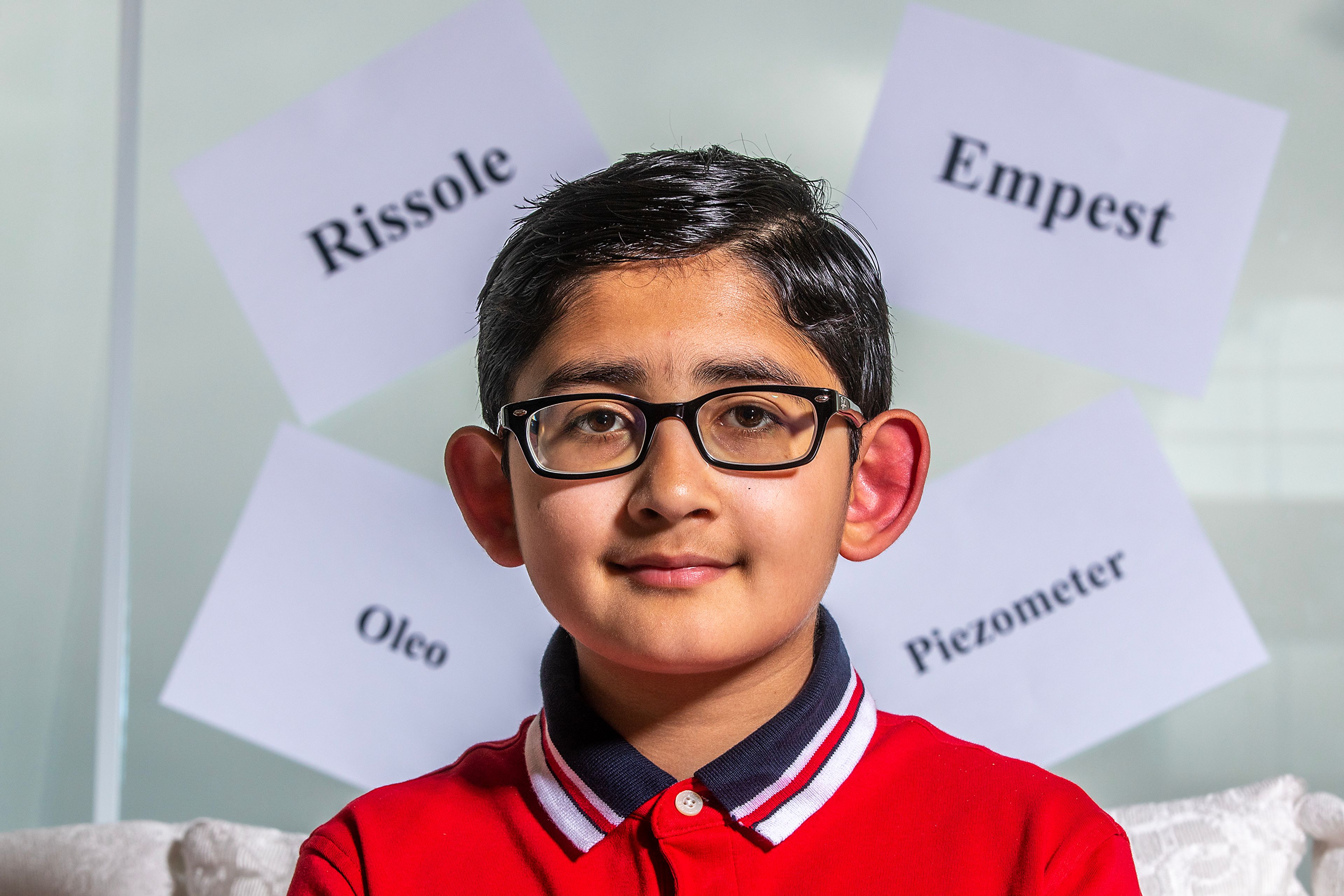 Navtaj Singh sits in his home in Pullman in front of words he spelled correctly in the Scripps Spelling Bee, where he placed 12th.