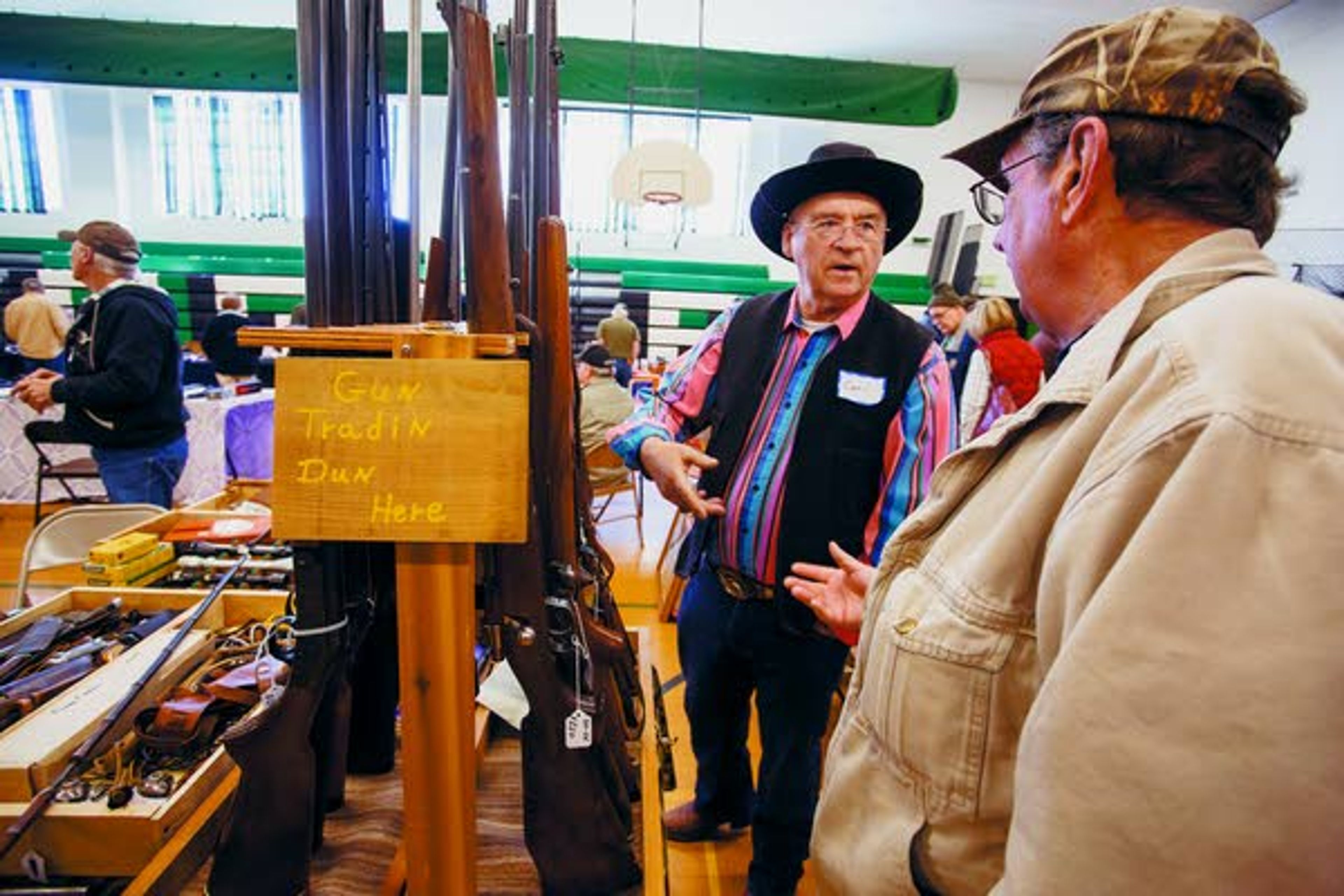 Jim Marston, right, of Kendrick, talks with exhibitor Carl Johnston, of Deary, during the Potlatch gun show on Sunday, March 16, 2014, at Potlatch Elementary School.