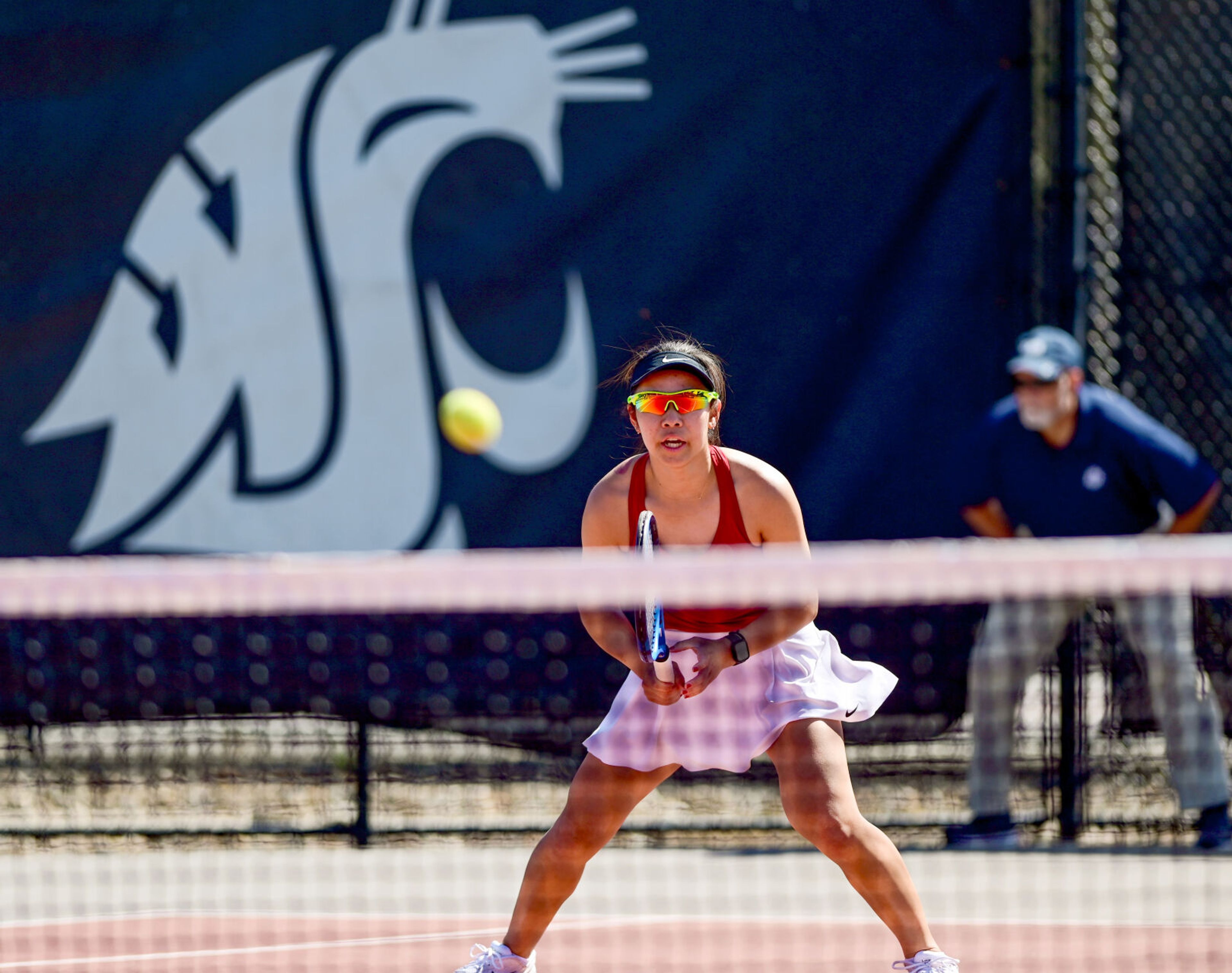 Washington State’s Yura Nakagawa prepares a return against Washington during a doubles match with fellow Cougar Fifa Kumhom in Pullman on Friday.