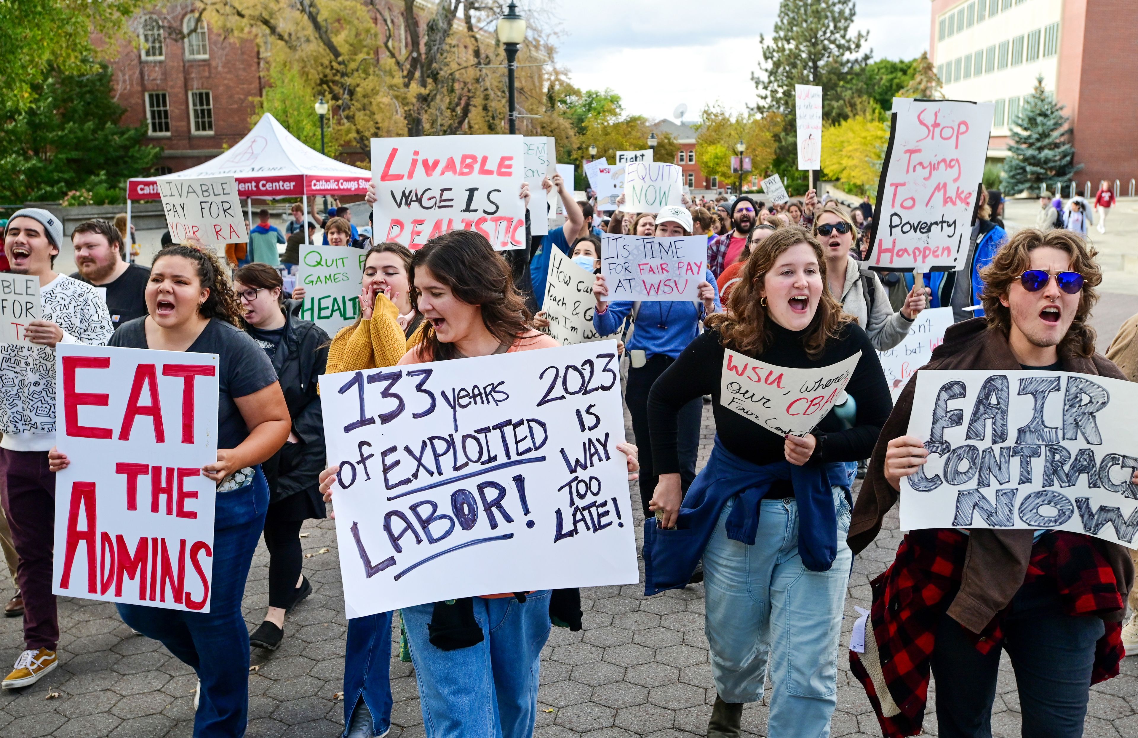 Washington State University students begin marching down Glenn Terrell Mall as part of a rally supporting contract negotiations for Academic Student Employees on Wednesday in Pullman.