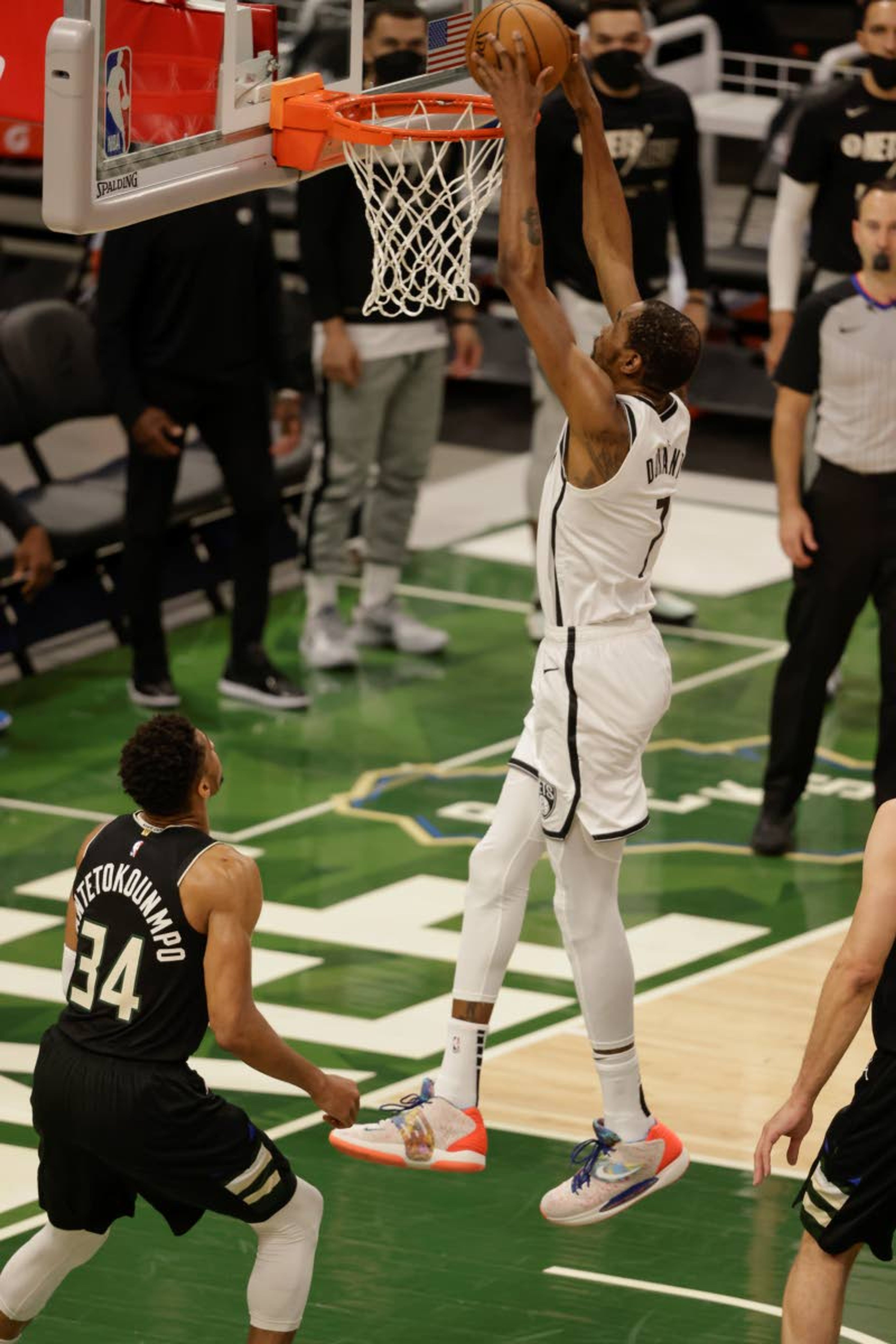 Brooklyn Nets forward Kevin Durant (7) dunks in front of Milwaukee Bucks forward Giannis Antetokounmpo (34) during the first half of Game 6 of a second-round NBA basketball playoff series Thursday, June 17, 2021, in Milwaukee. (AP Photo/Jeffrey Phelps)