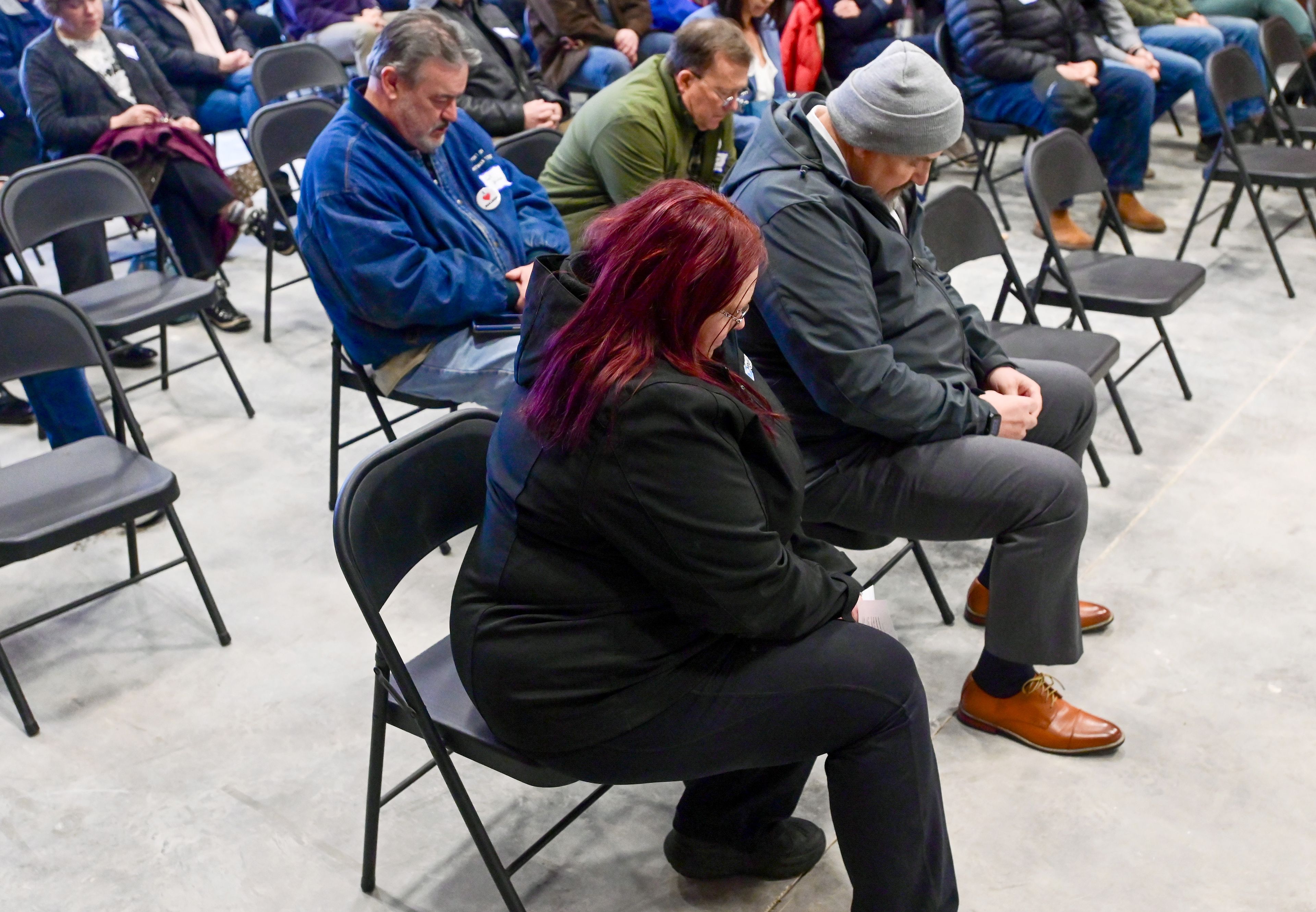 Heads bow for a blessing before the ribbon cutting for Malden’s new facilities building on Thursday.