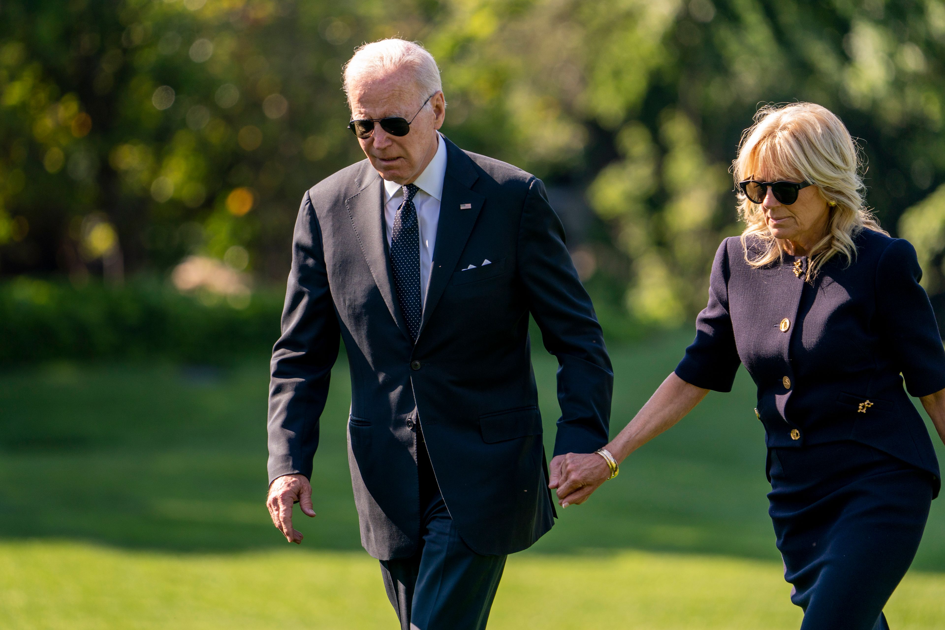 President Joe Biden and first lady Jill Biden walk across the South Lawn of the White House in Washington, Monday, May 30, 2022, after returning from Wilmington, Del. (AP Photo/Andrew Harnik)