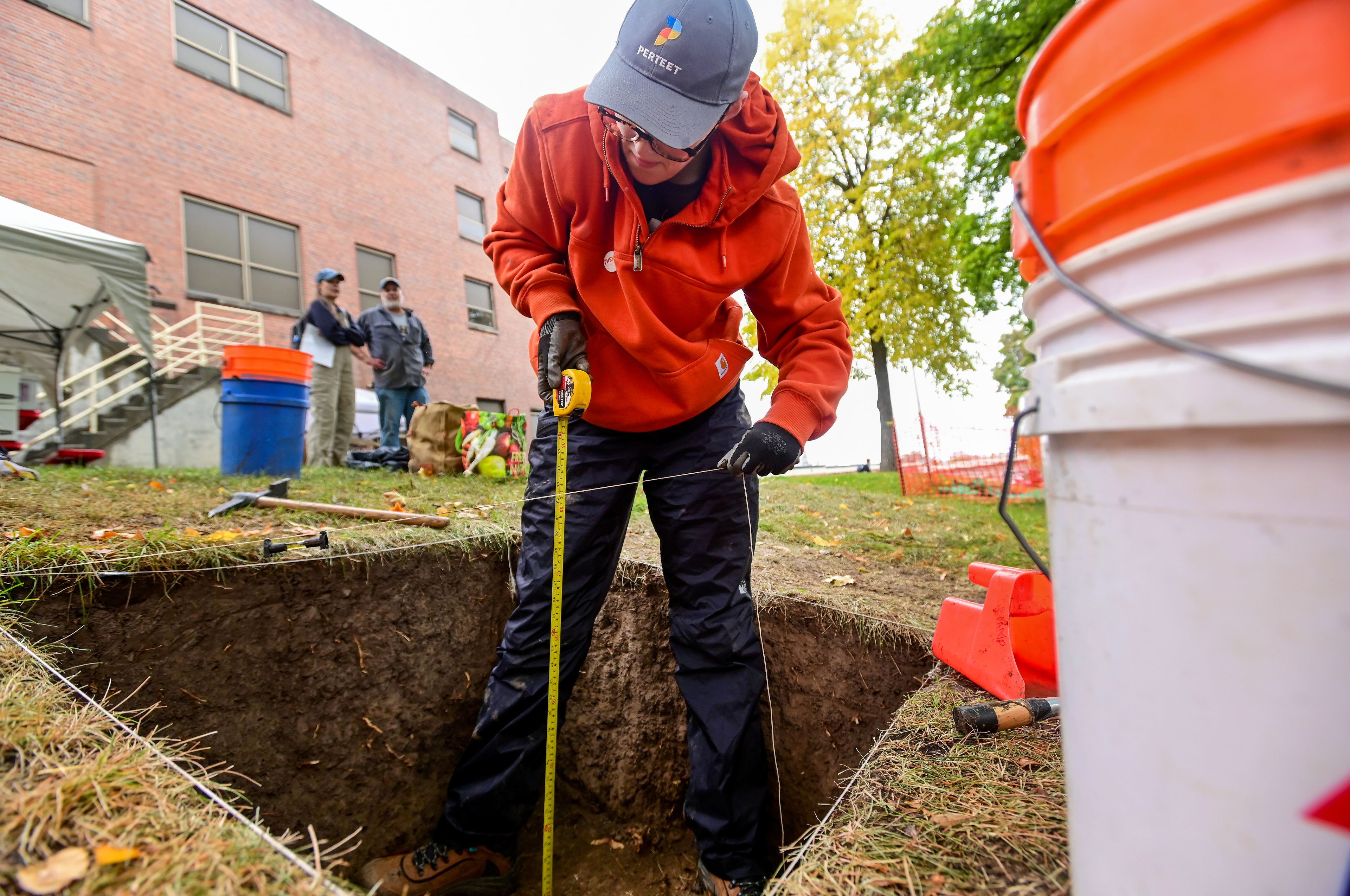 Trinity Hunter, a second-year graduate student at the University of Moscow, works to level out a portion of the excavation project at Moscow High School on Tuesday.