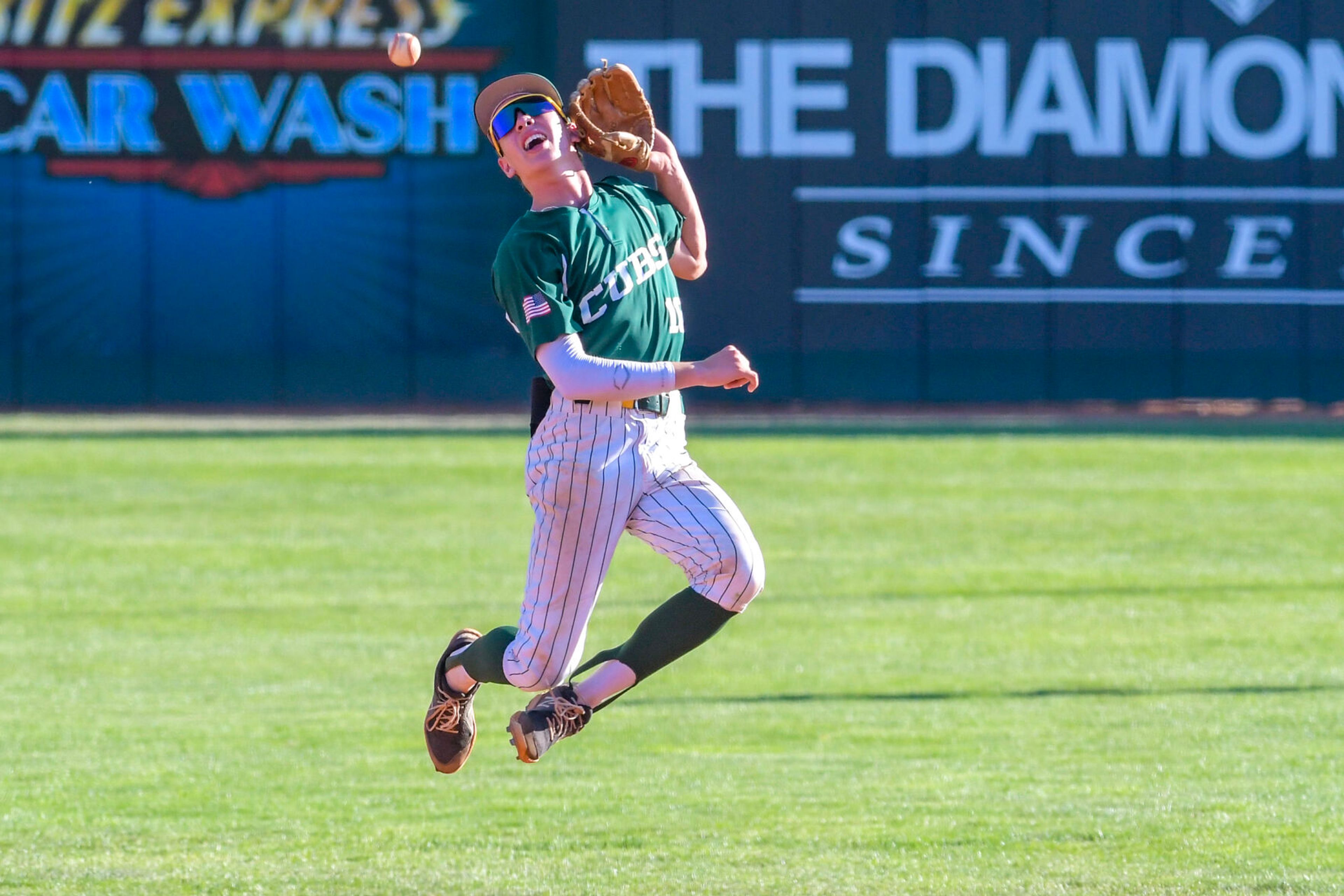 Lewis-Clark Cubs shortstop Jimmy Woody attempts a catch against the Blue Devils in a game of the Clancy Ellis Tournament on Saturday at Harris Field in Lewiston.