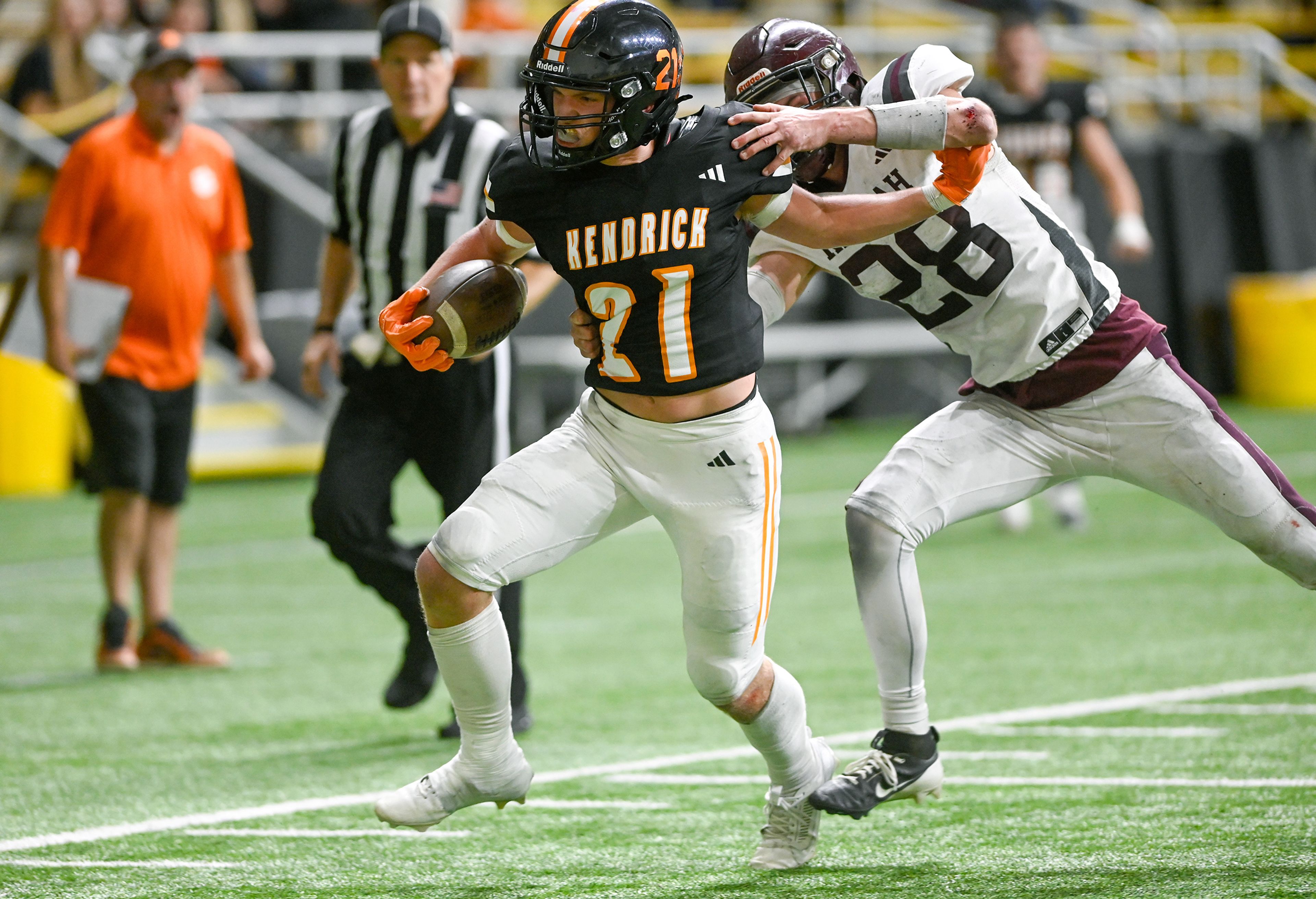 Kendrick’s Nathan Kimberling pushes free from Kamiah’s Dave Kludt to carry the ball to the end zone for a touchdown during an Idaho Class 2A state quarterfinal game at the P1FCU Kibbie Dome in Moscow.