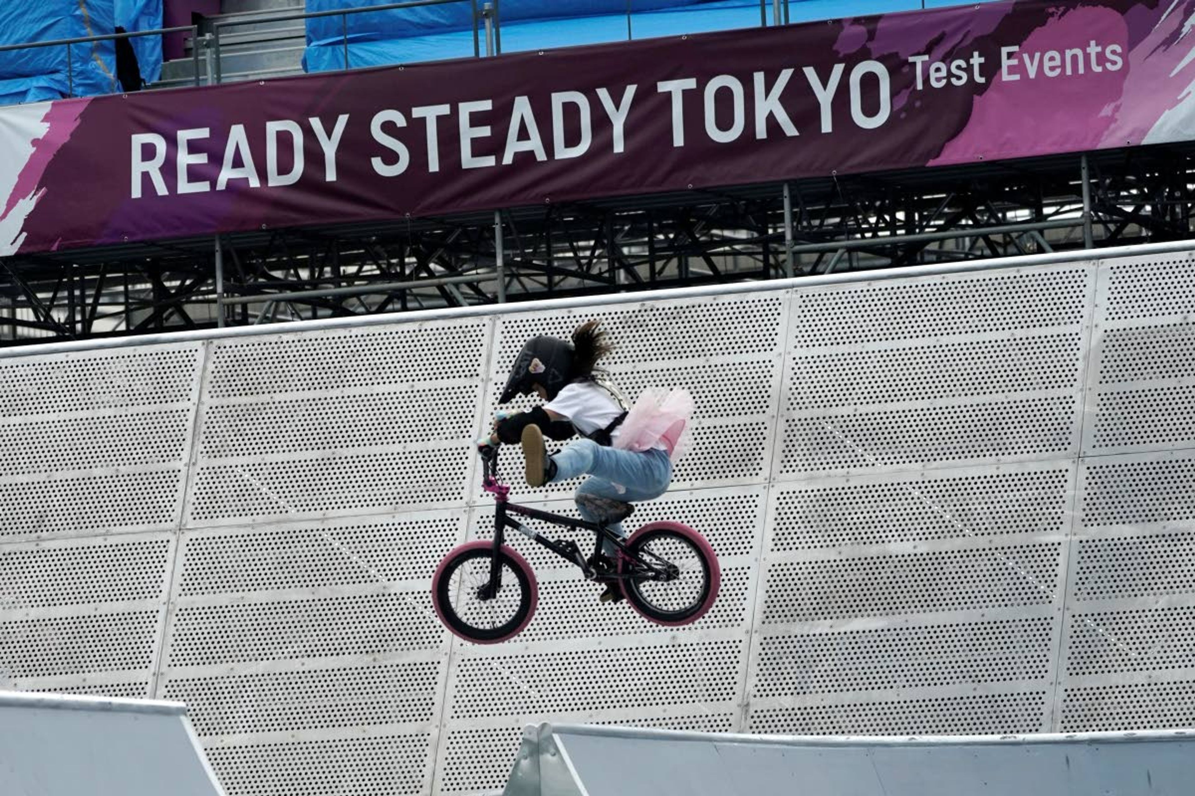 FILE - In this May 17, 2021, file photo, a local athlete competes during the Tokyo 2020 Olympic Game Cycling BMX Freestyle test event at Olympic BMX Course of Ariake Urban Sports Park in Tokyo. IOC officials say the Tokyo Olympics will open on July 23 and almost nothing now can stop the games from going forward. (AP Photo/Eugene Hoshiko, File)