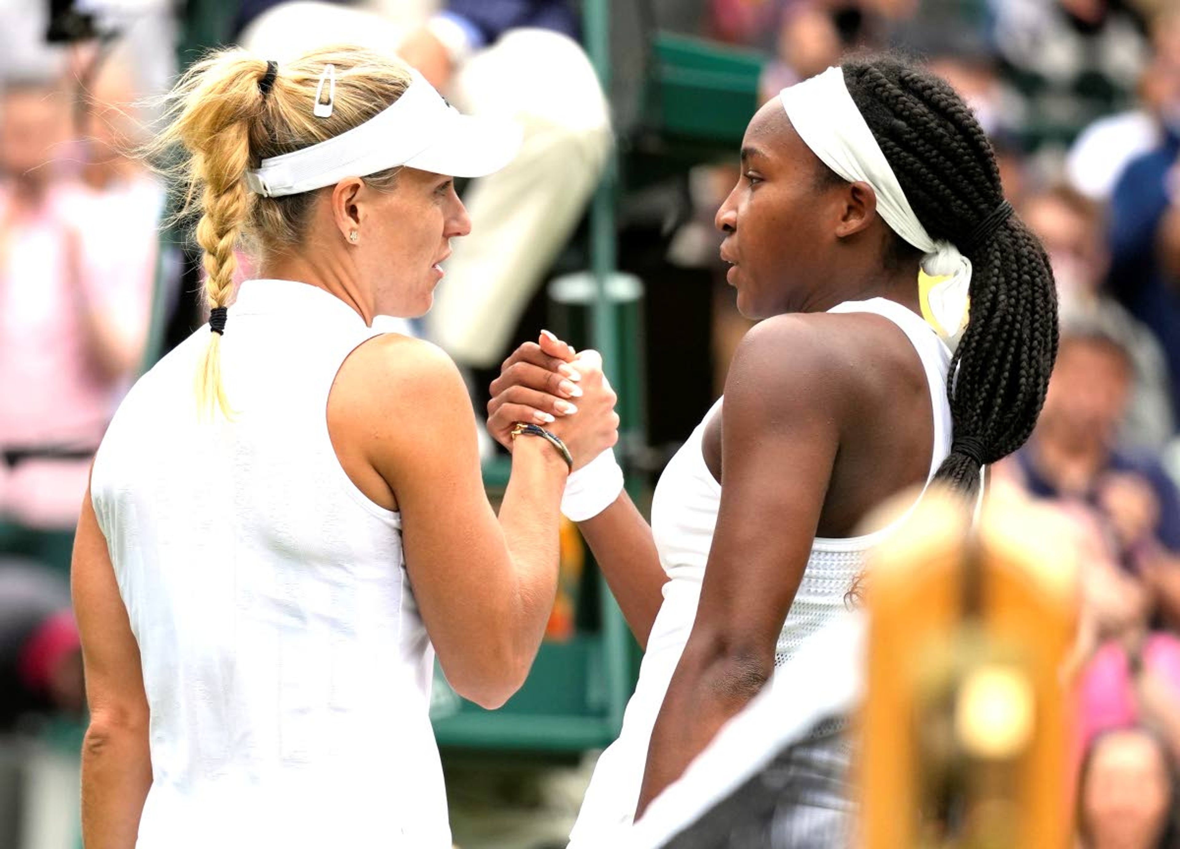 Germany's Angelique Kerber, left, greets Coco Gauff of the U.S. after winning the women's singles fourth round match on day seven of the Wimbledon Tennis Championships in London, Monday, July 5, 2021. (AP Photo/Kirsty Wigglesworth)