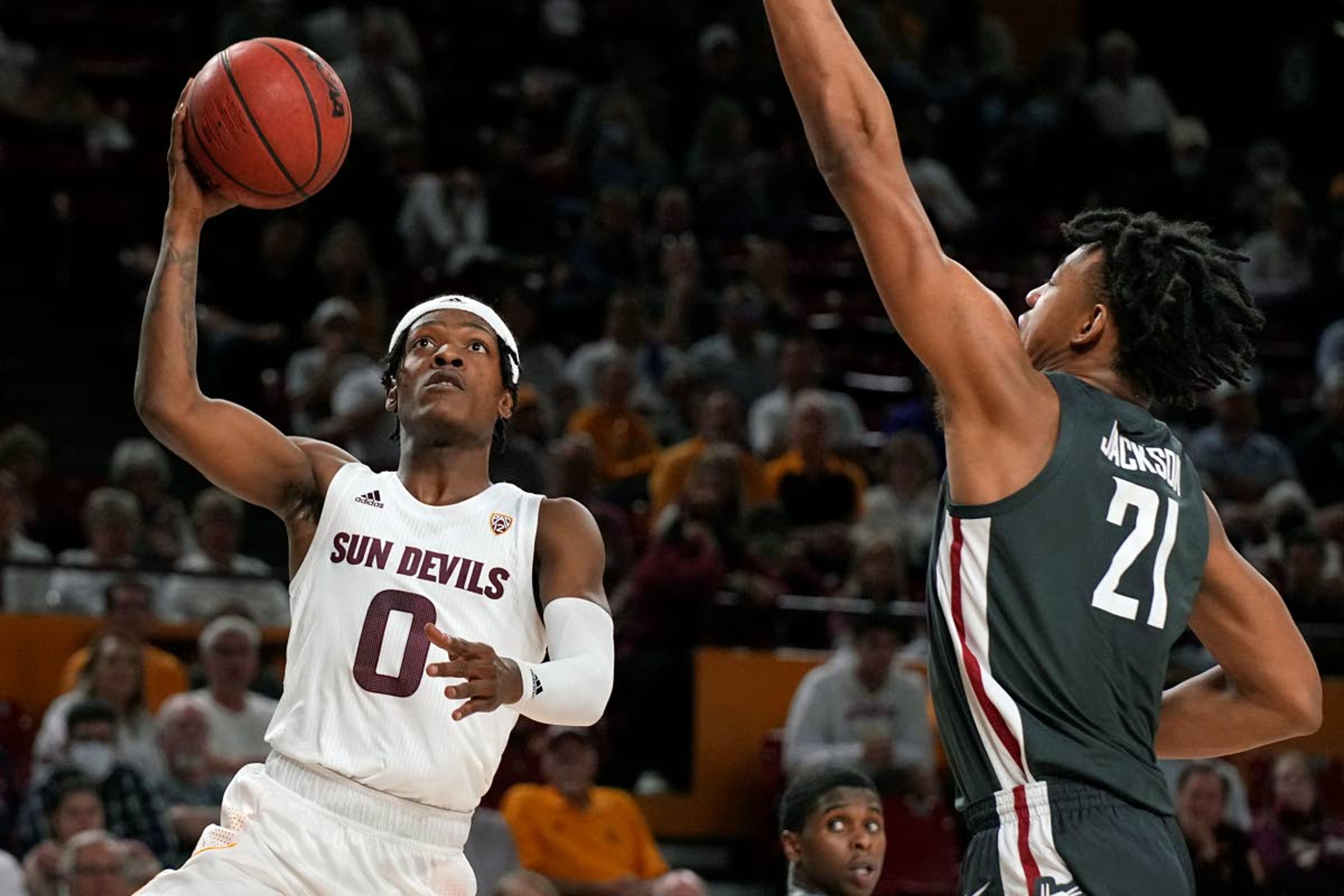 Arizona State guard DJ Horne drives by Washington State center Dishon Jackson (21) during the second half of an NCAA college basketball game, Wednesday, Dec. 1, 2021, in Tempe, Ariz. Washington State won 51-29. (AP Photo/Rick Scuteri)