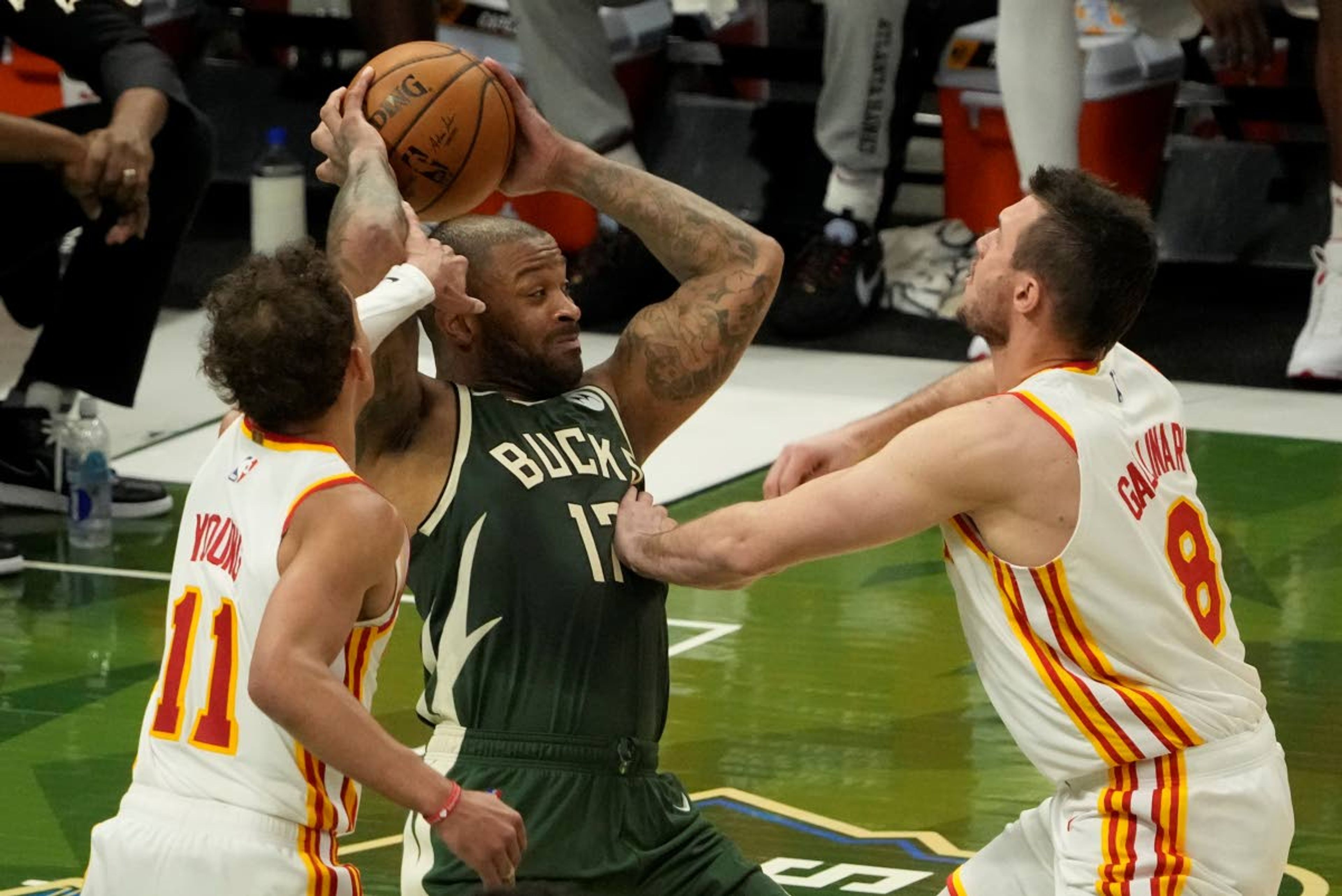 Atlanta Hawks' Onyeka Okongwu is defended by Atlanta Hawks' Trae Young and Danilo Gallinari during the second half of Game 1 of the NBA Eastern Conference basketball finals game Wednesday, June 23, 2021, in Milwaukee. (AP Photo/Morry Gash)