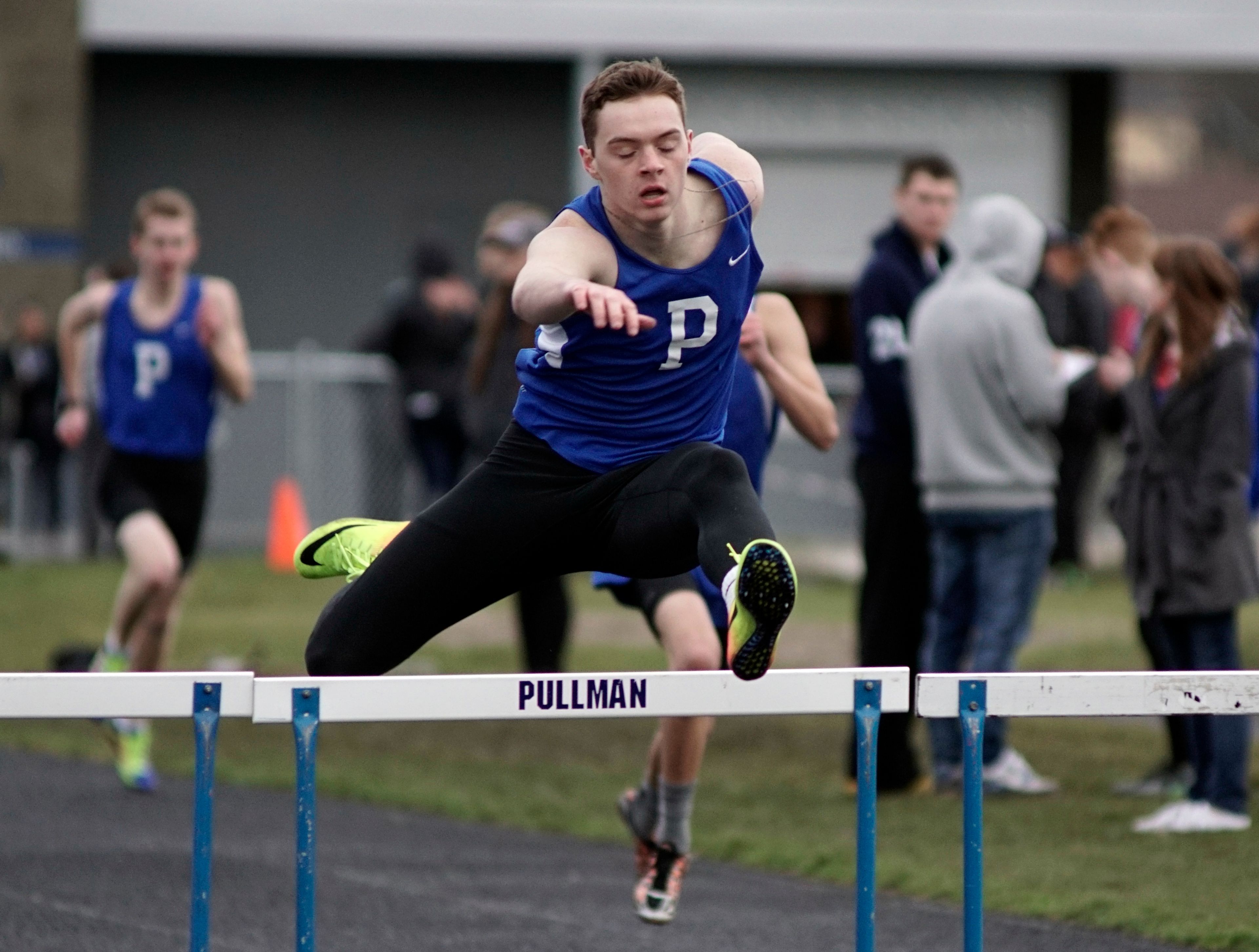 Pullman's Joe Tingstad clears a hurdle on his way to winning the 300 meter event during a dual meet with Clarkston on Wednesday in Pullman.