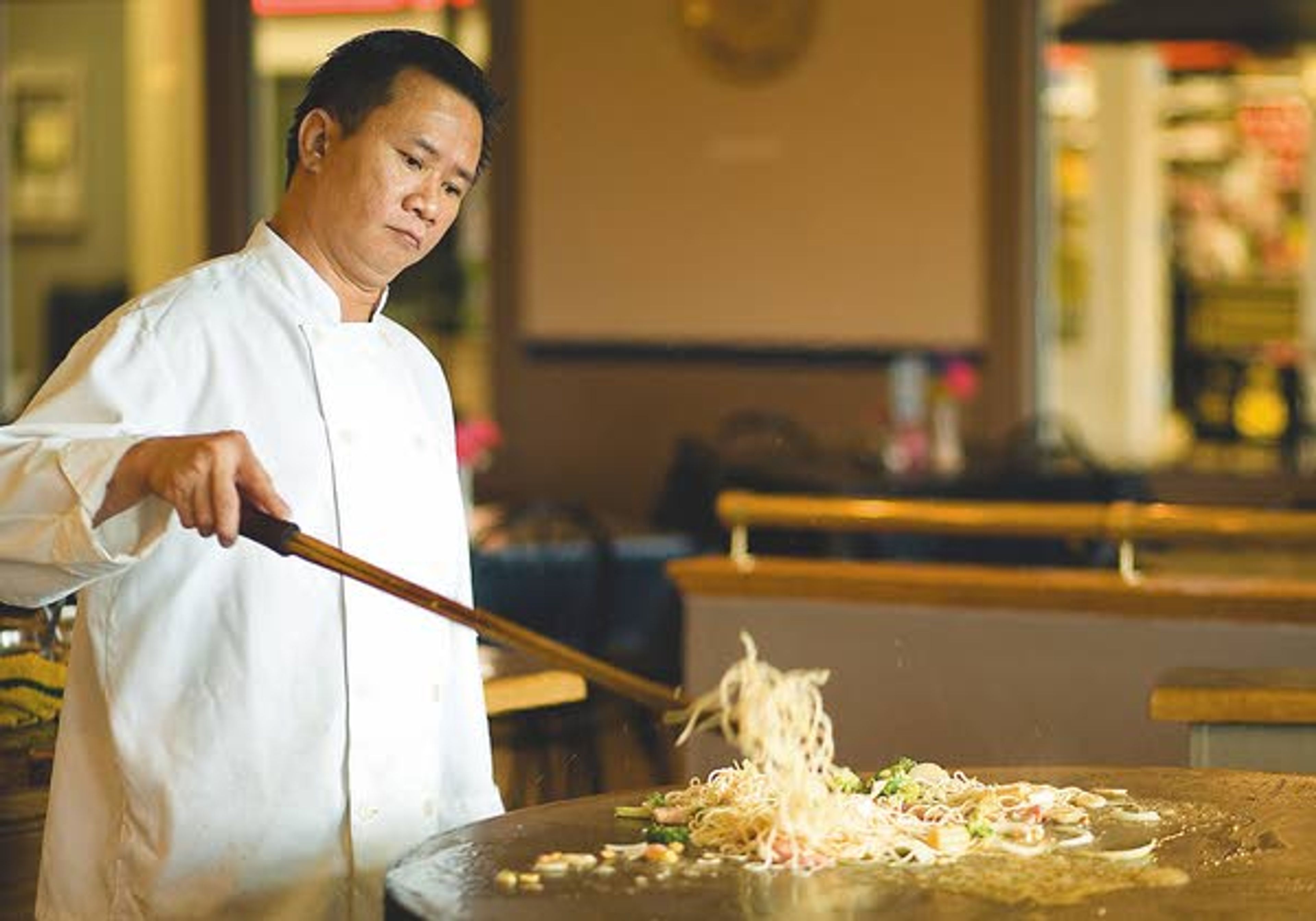 Hieu Pham cooks a customer's meal the the Mongolian BBQ Express at the Eastside Marketplace in Moscow on Tuesday.