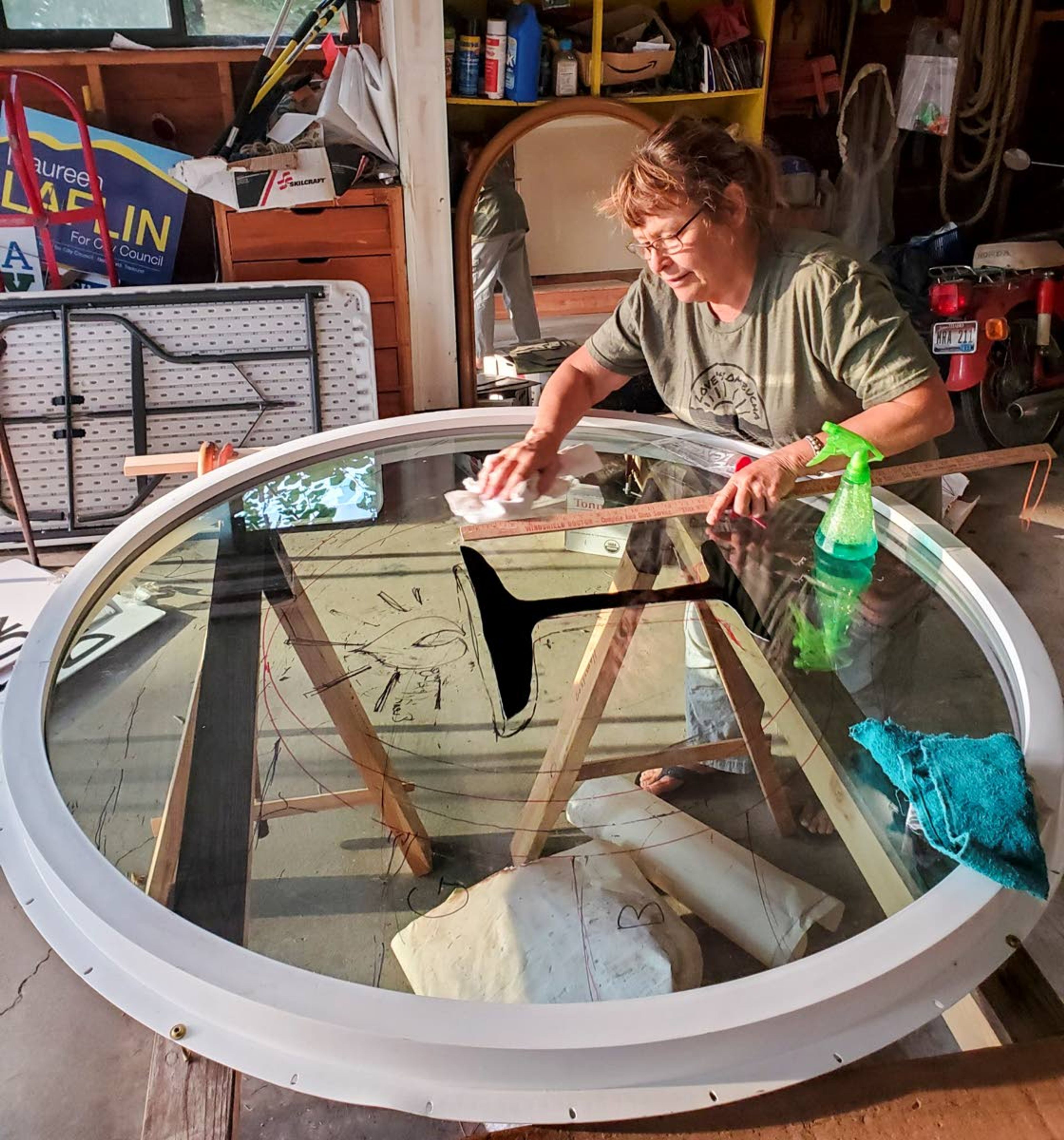 Artist Pamela Arborgreen works on a glass window for the Unitarian Universalist Church of the Palouse in her workshop.