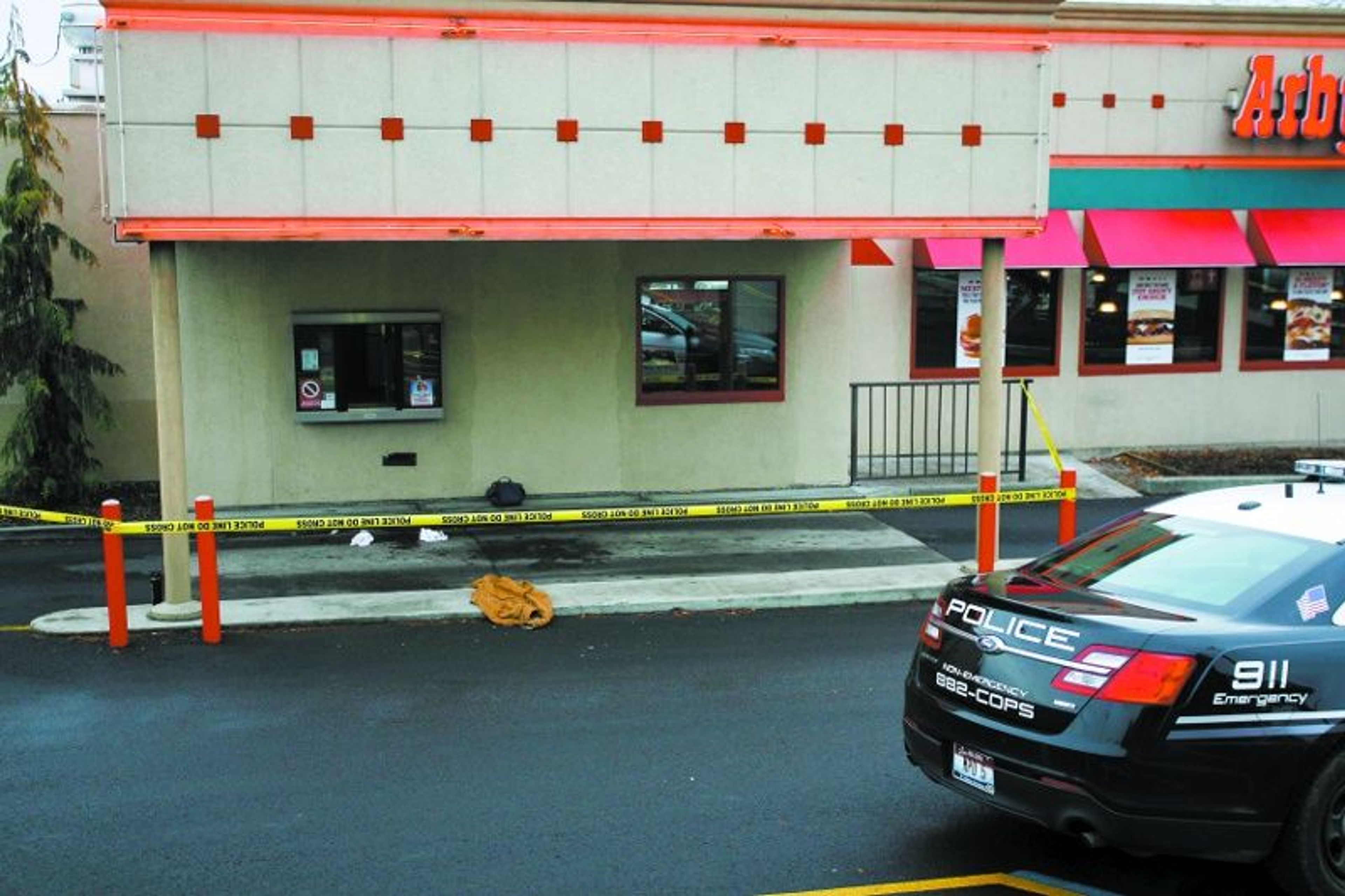 Police tape surrounds the drive-thru at Arby's restaurant in Moscow following a shooting Saturday.