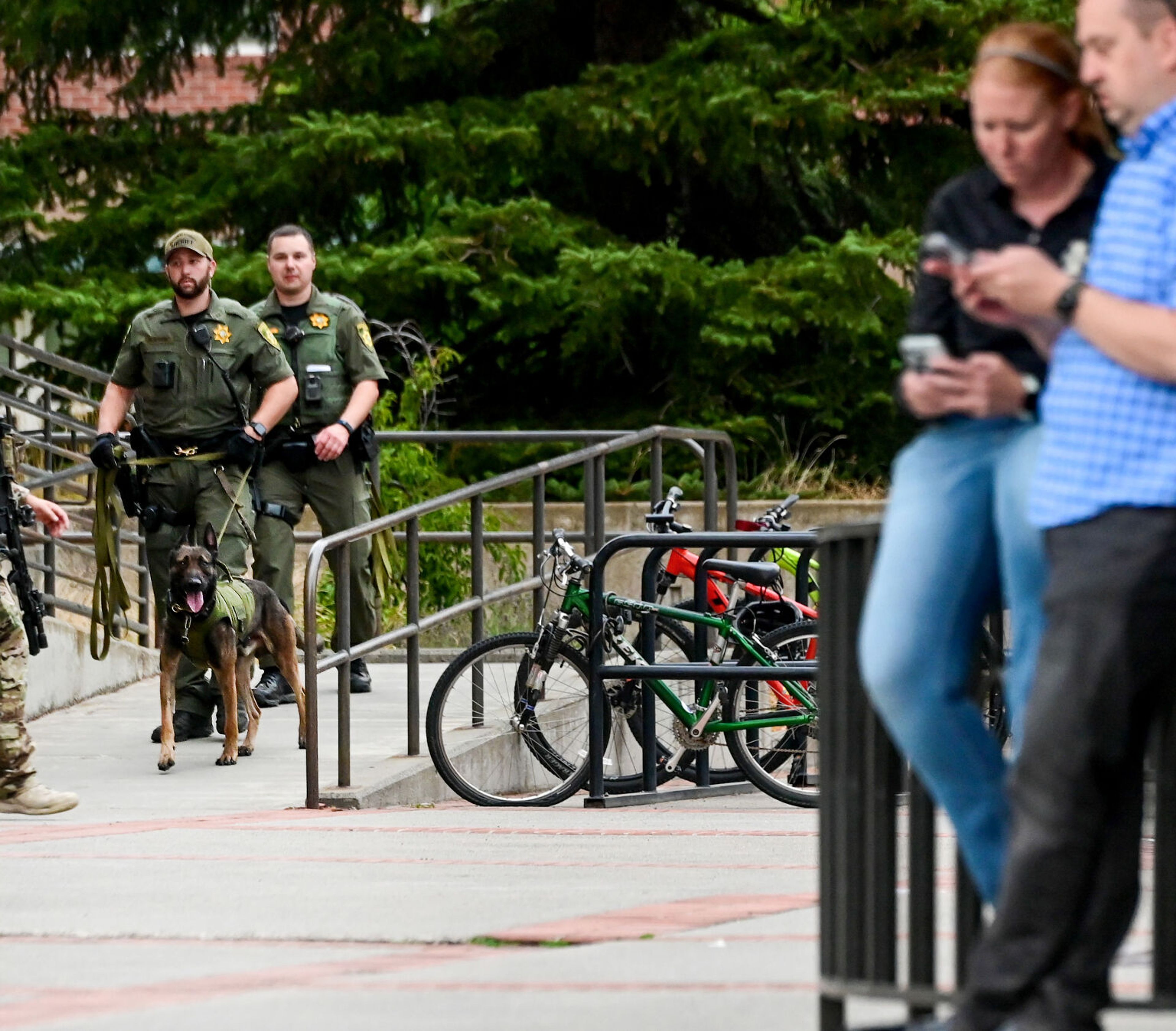 A police dog exits Theophilus Tower on the University of Idaho campus on Tuesday in Moscow. Officers responded to reports that an inmate walked away from a cleaning crew in the dormitory that afternoon.