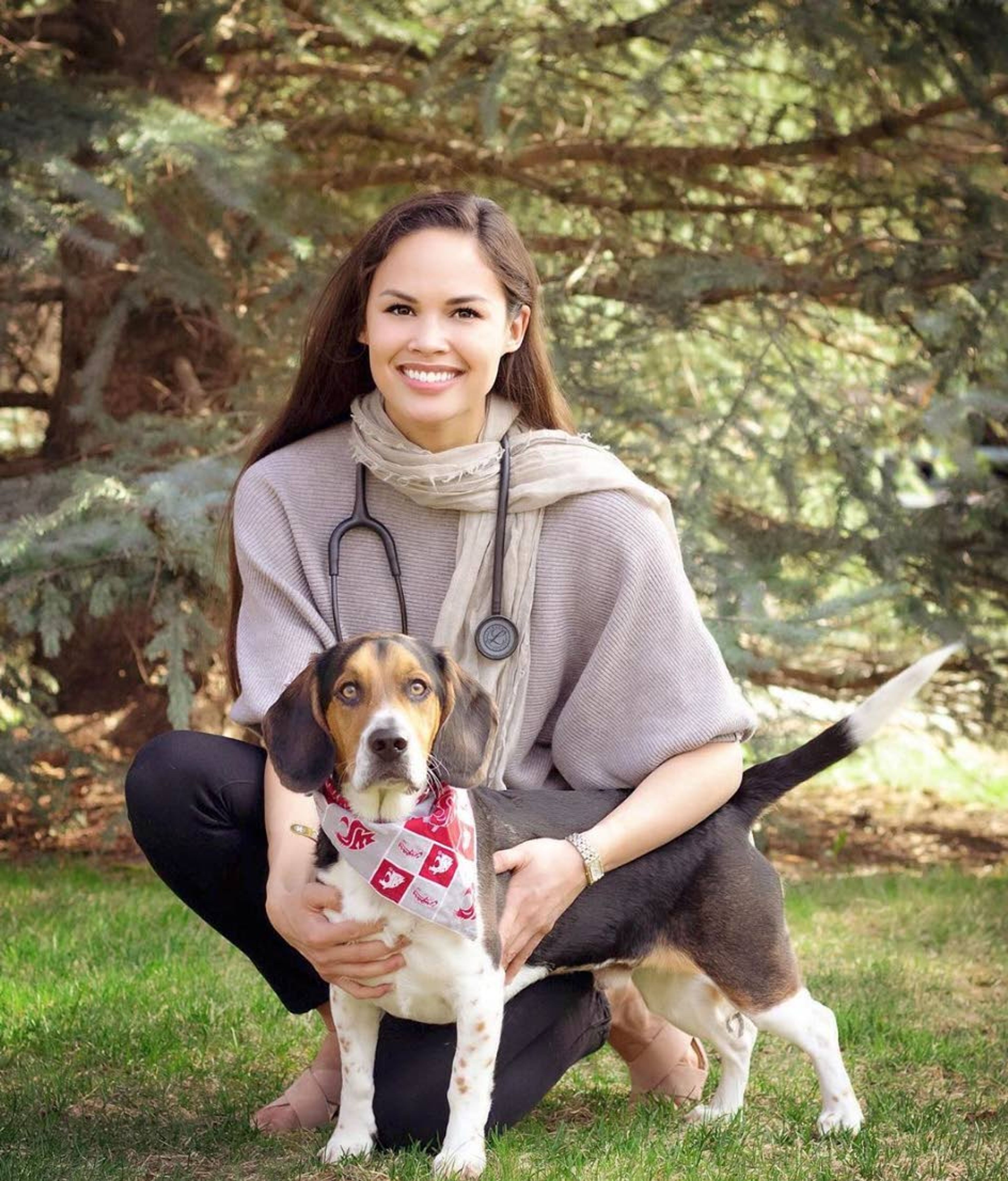 Kim Layne, Miss Idaho USA 2020 and a vet student at Washington State University, poses with a friend’s dog, Hank, on the WSU campus.