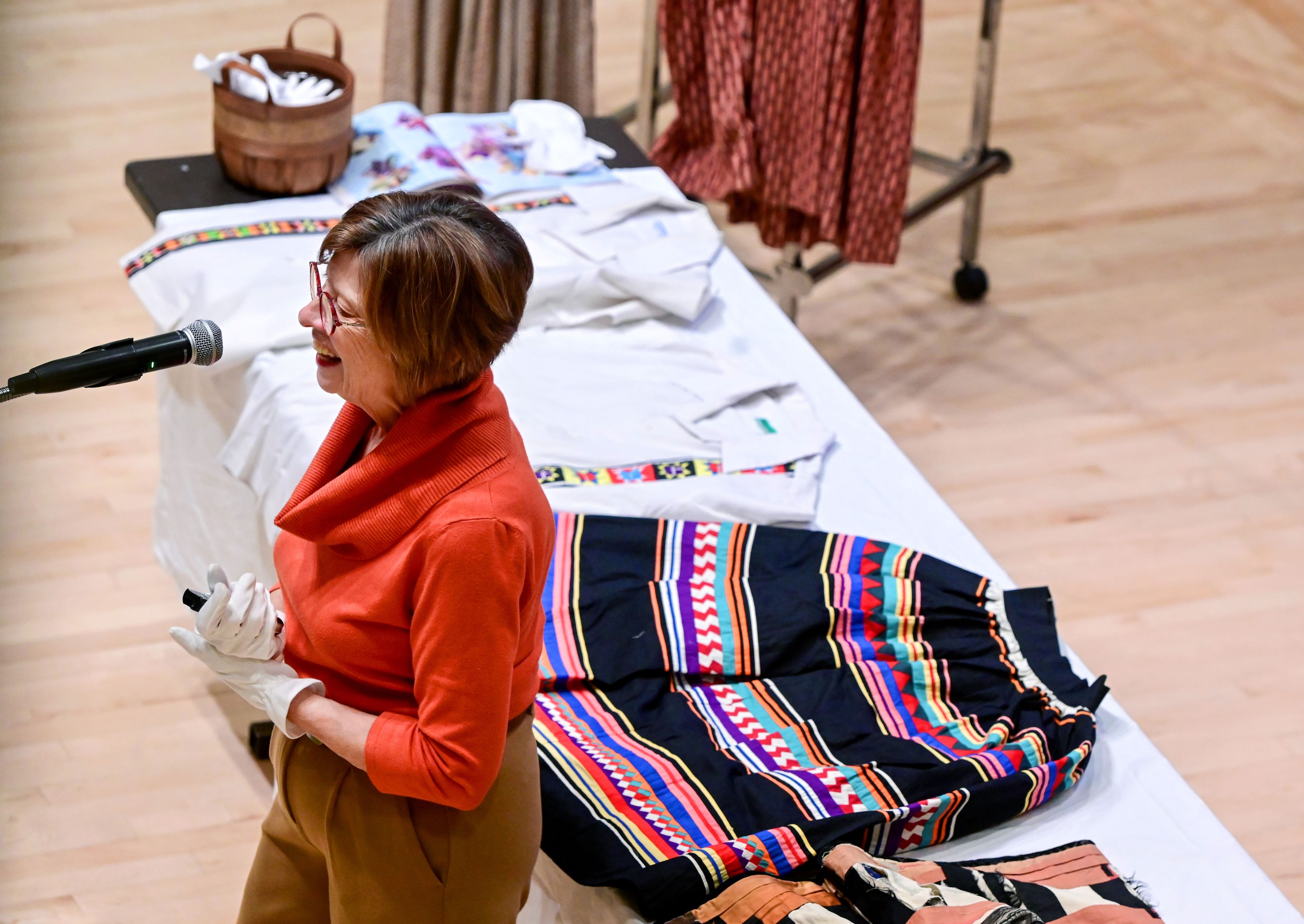 Sonya Meyers, University of Idaho professor and curator of the Leila Old Historic Costume Collection, speaks on the collection during a Palouse Patchers meeting at the 1912 Center in Moscow on Tuesday. Pieces from the collection sit behind Meyers as she speaks.