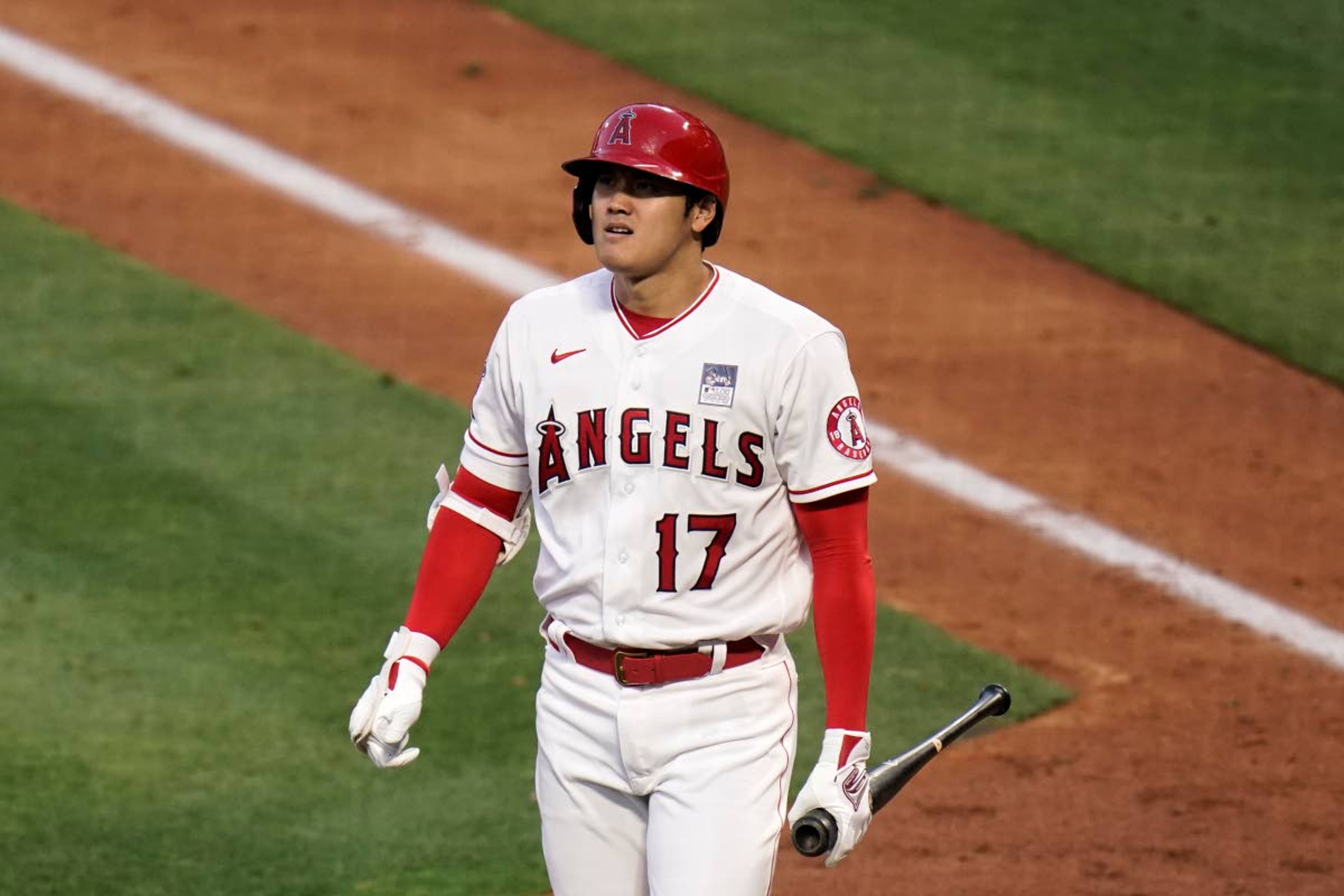 Los Angeles Angels' Shohei Ohtani heads to the dugout after striking out during the third inning of the team's baseball game against the Seattle Mariners in Anaheim, Calif., Thursday, June 3, 2021. (AP Photo/Jae C. Hong)