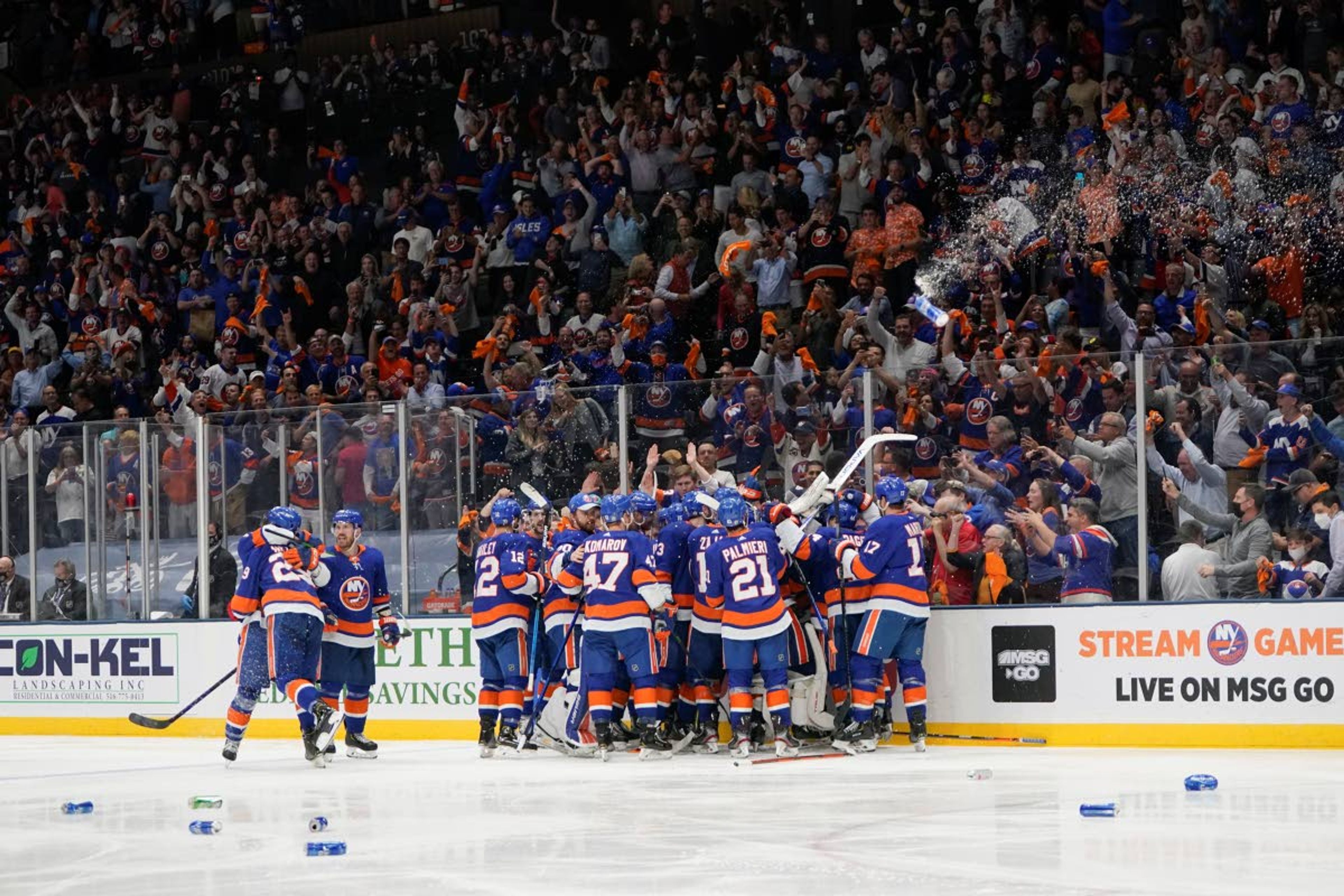 Fans cheer as the New York Islanders celebrates after Game 6 of an NHL hockey semifinals against the Tampa Bay Lightning Wednesday, June 23, 2021, in Uniondale, N.Y. The Islanders won 3-2. (AP Photo/Frank Franklin II)