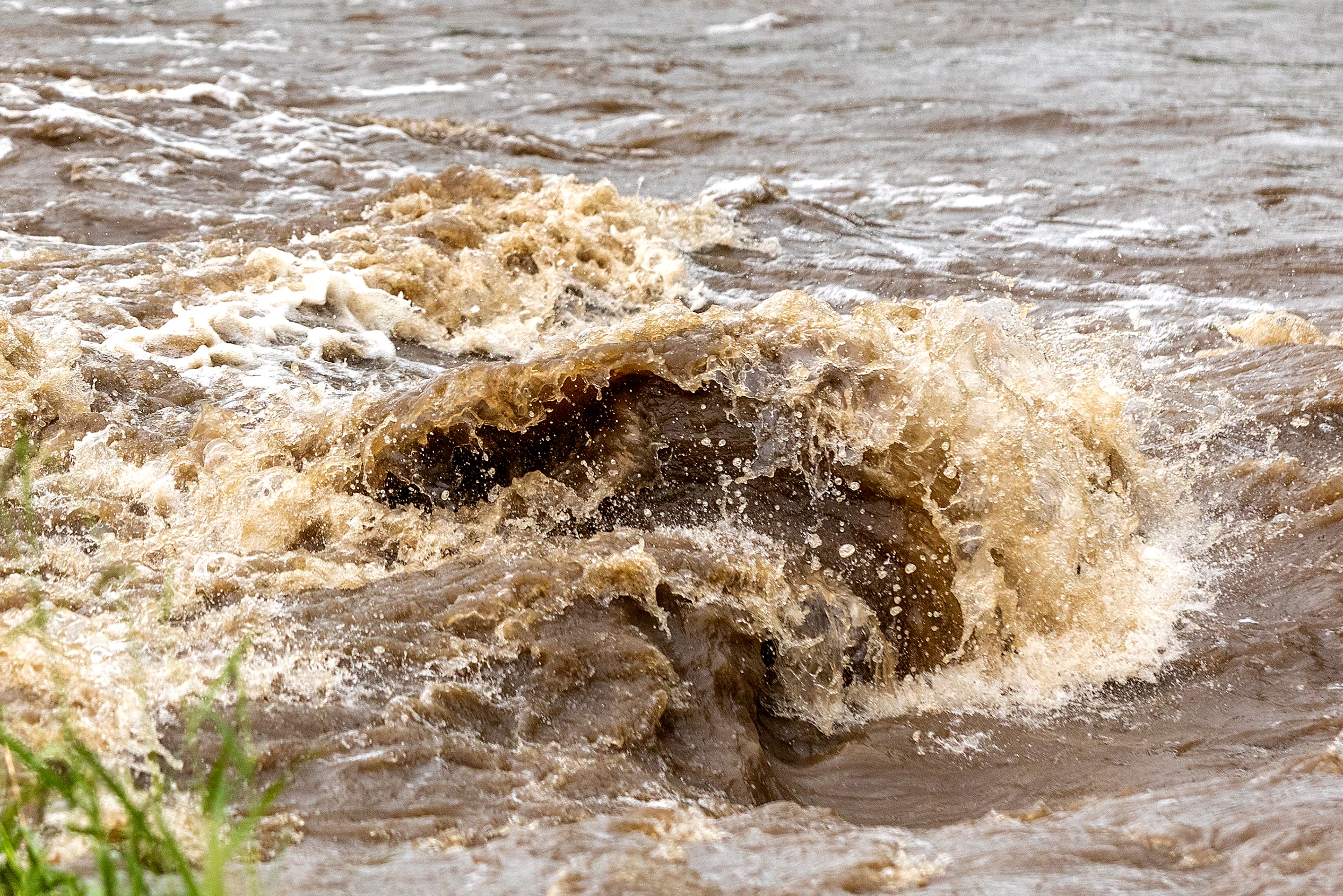 Water churns Monday in Lapwai Creek next to U.S. Highway 95.