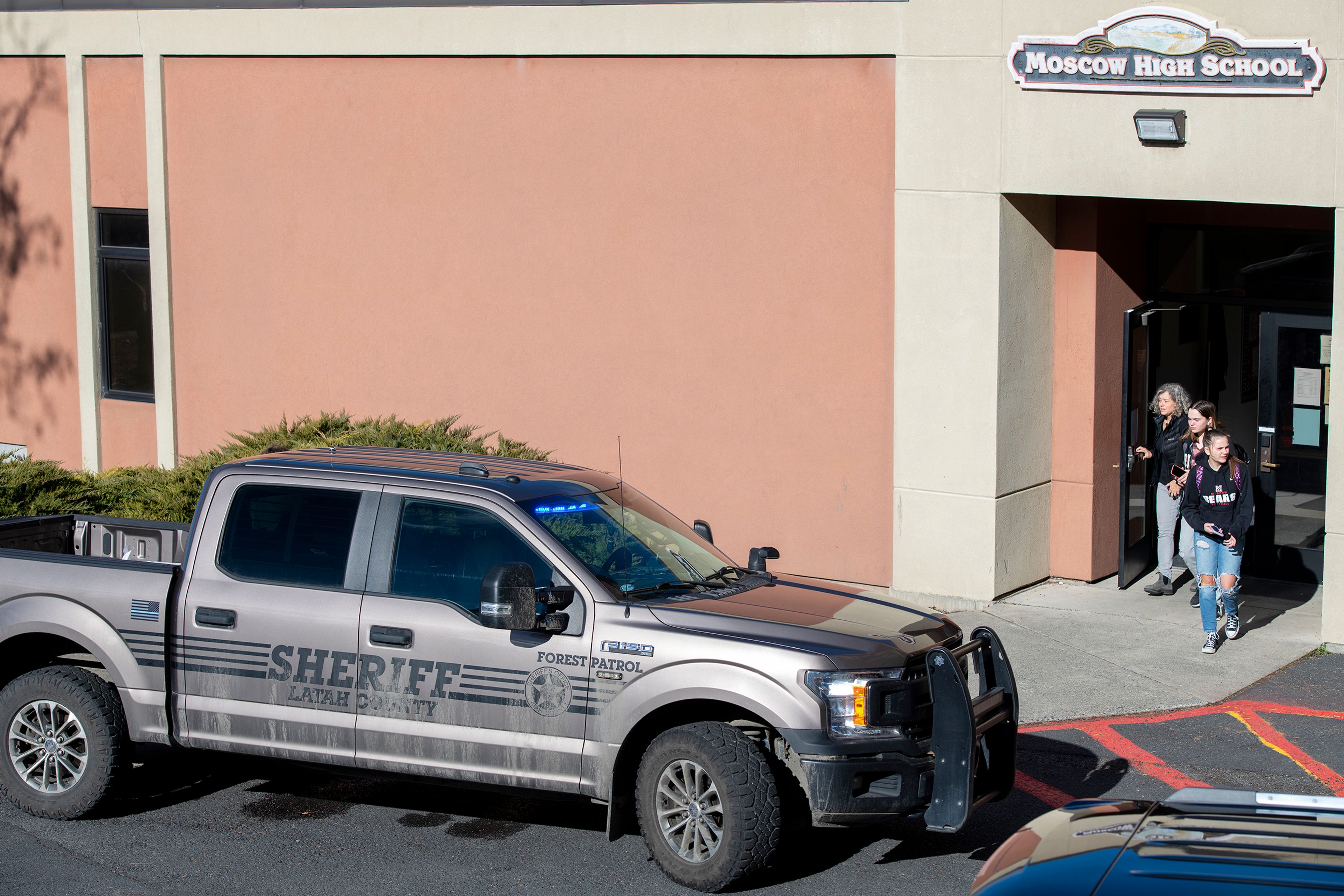 Moscow High School students exit the building following Latah County Sheriff’s Office deputies’ search for an active threat on campus.