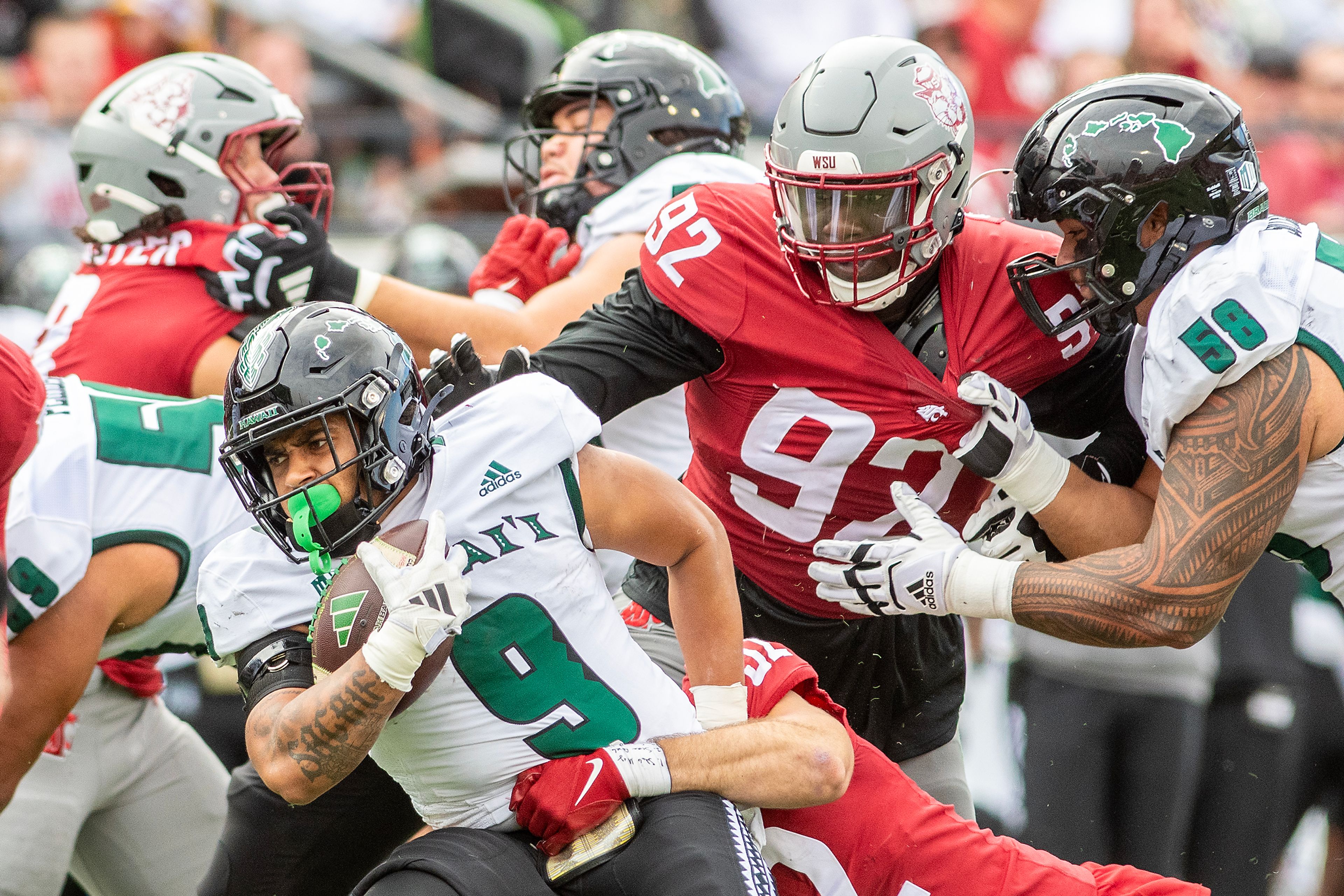 Hawaii running back Cam Barfield is tackled by Washington State linebacker Kyle Thornton in a college football game on Saturday at Gesa Field in Pullman.,