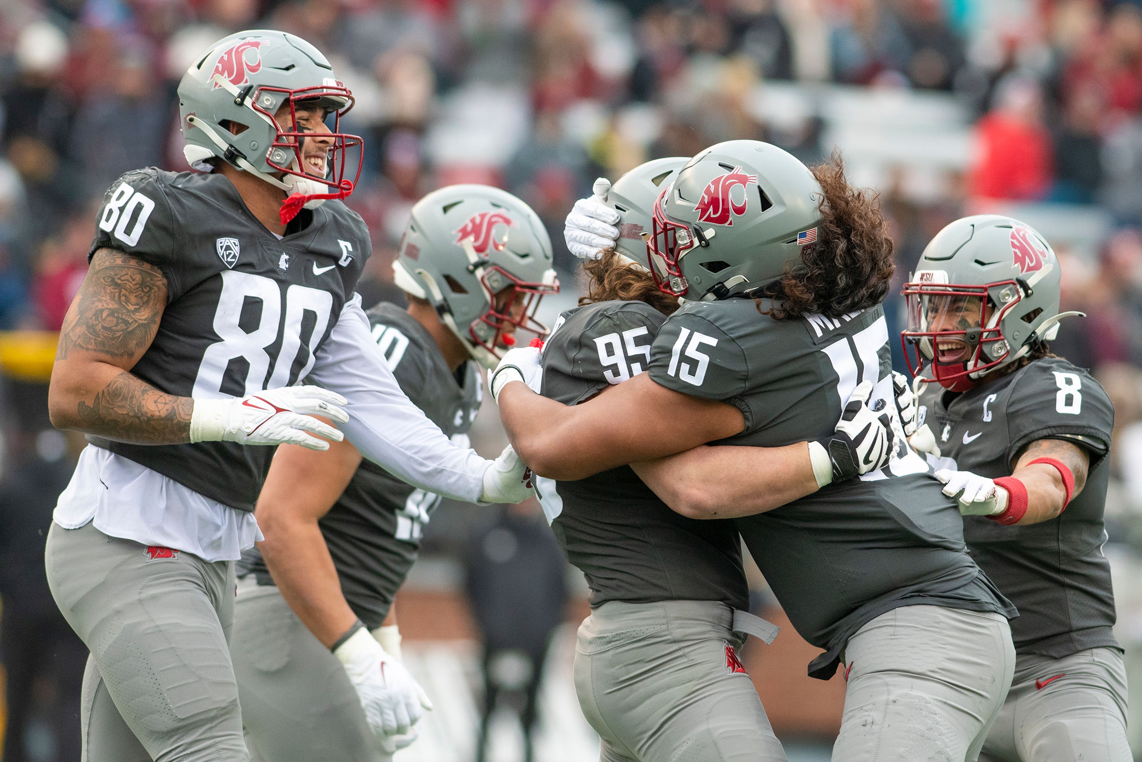 Washington State Cougars defensive end Andrew Edson (95) hugs defensive lineman Nusi Malani (15) after sacking Arizona State Sun Devils quarterback Emory Jones (5) during the second quarter of a Pac-12 Conference game at Martin Stadium in Pullman on Saturday. The Cougars defeated the Sun Devils 28-18.