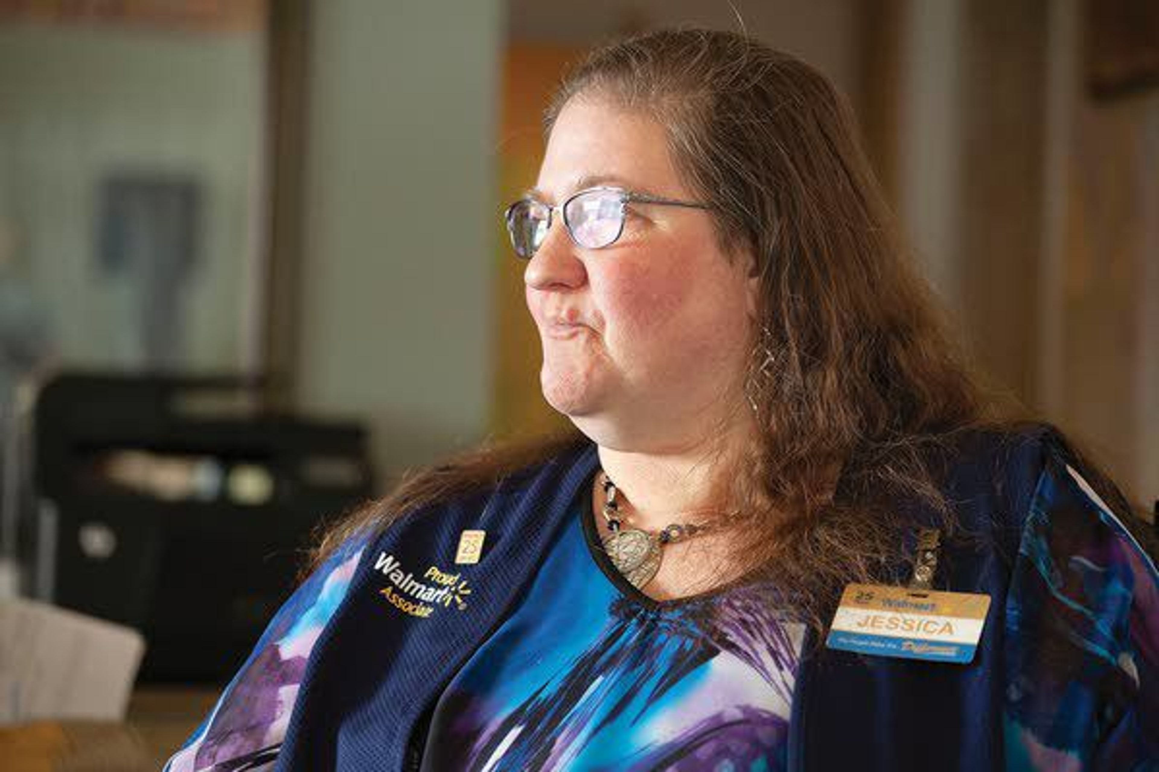 Jessica Bergman talks about her job at Walmart on Tuesday at her home in Moscow. Bergman, who has worked at Walmart for 25 years, learned that her position will be eliminated as part of a nationwide layoff of Walmart greeters.