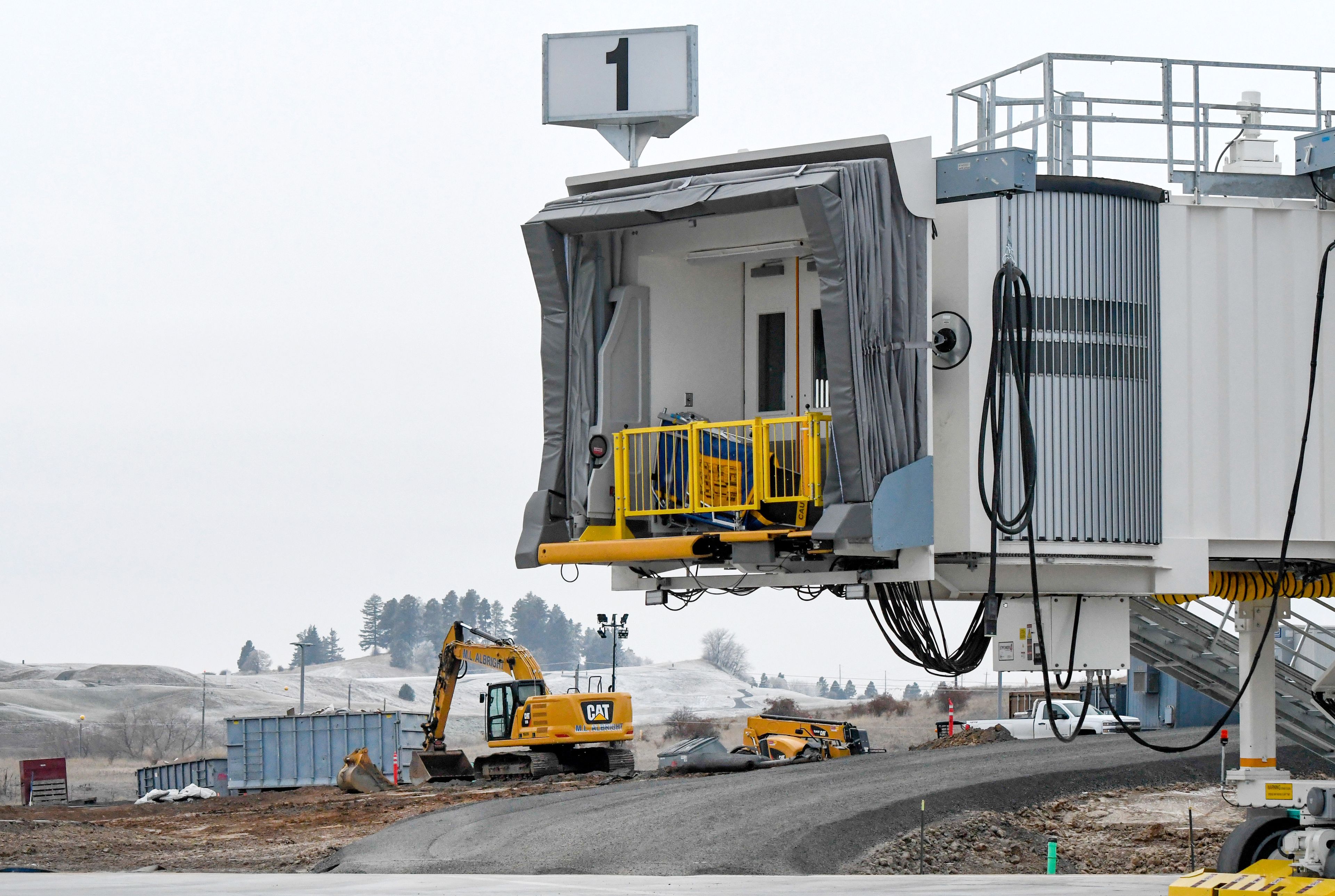 One of two passenger boarding bridges sits attached to the runway side of the new terminal for the Pullman-Moscow Regional Airport as construction continues on the building on Thursday.